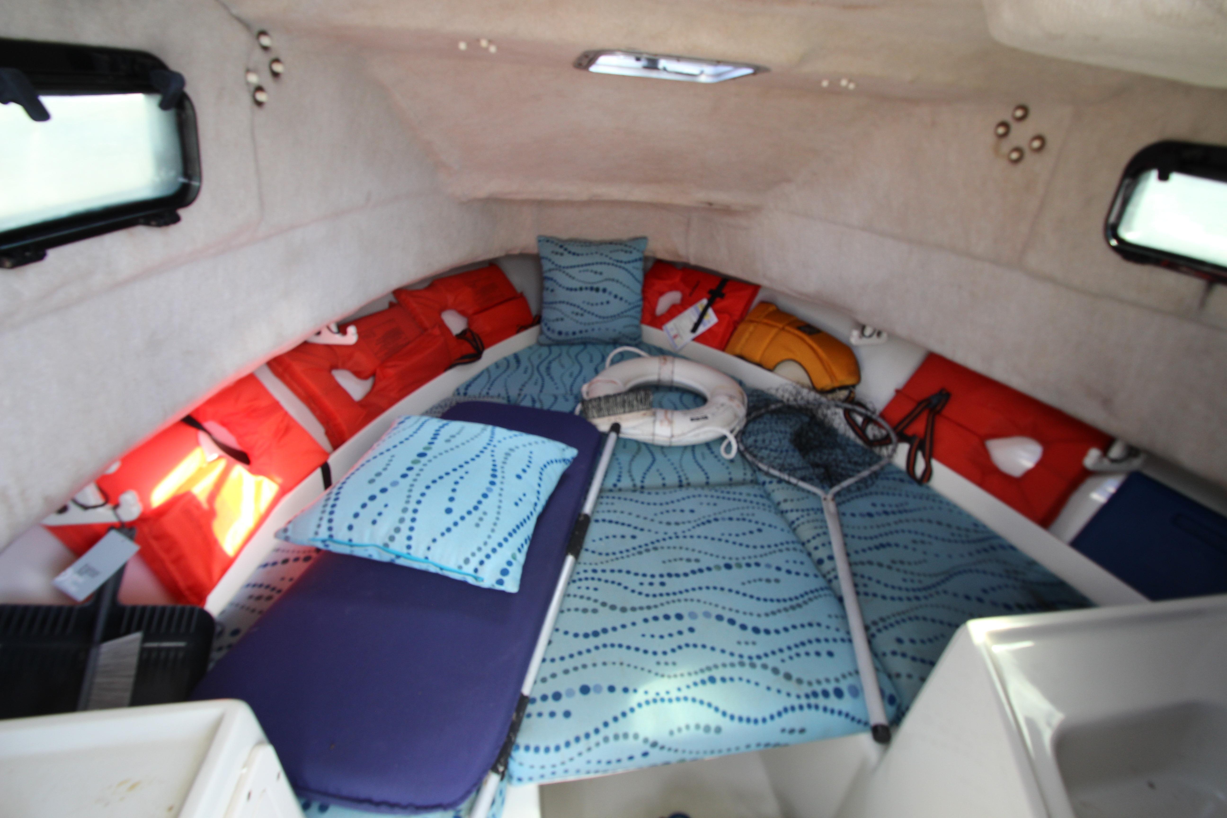 Interior cabin of 2002 Hydra-Sports 230 WA boat with life jackets and fishing gear.