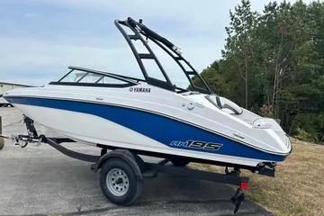 2026 Yamaha Boats AR195 on trailer, blue and white design, parked outdoors.