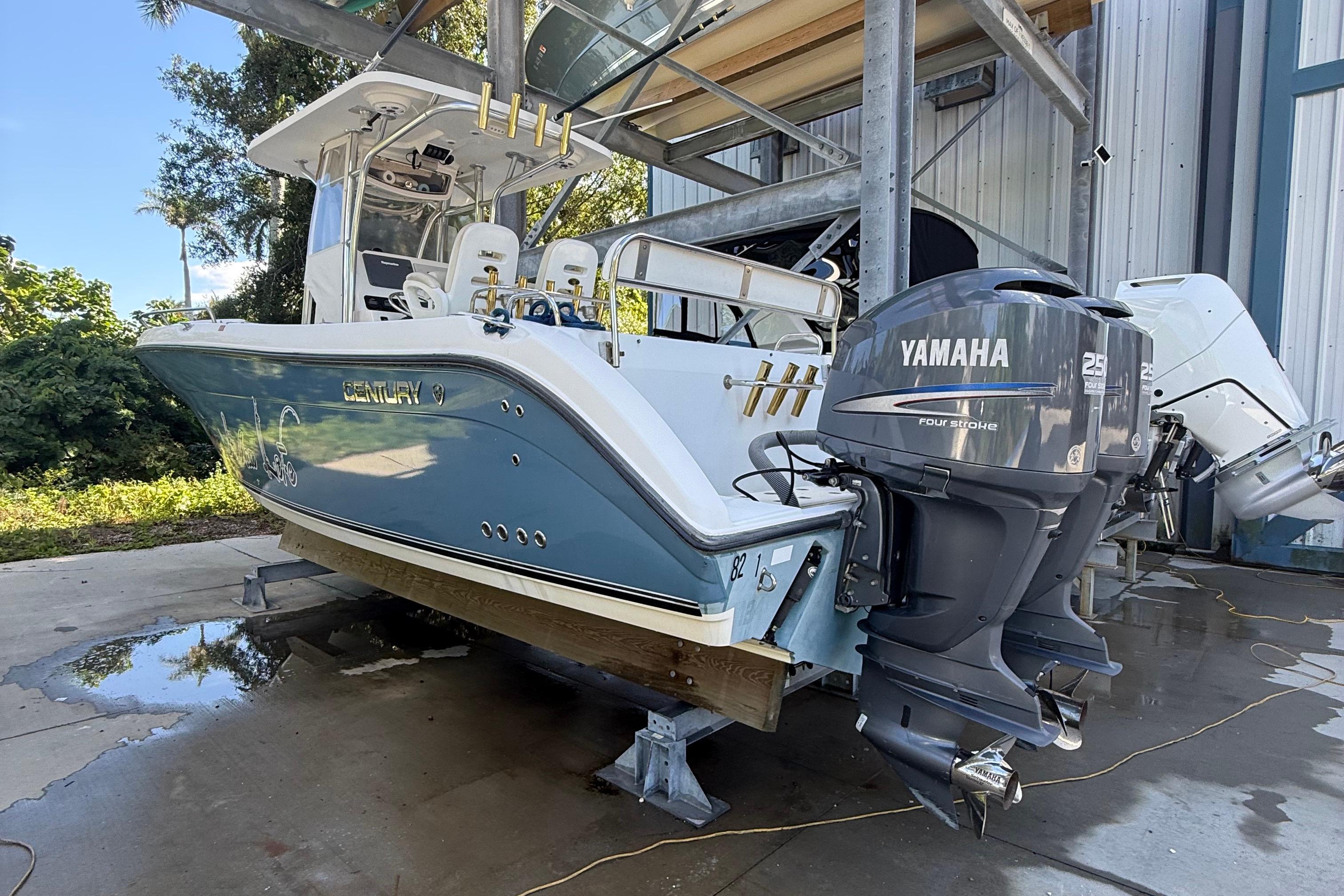 2008 Century 2901 Center Console boat with Yamaha engines, docked outdoors.