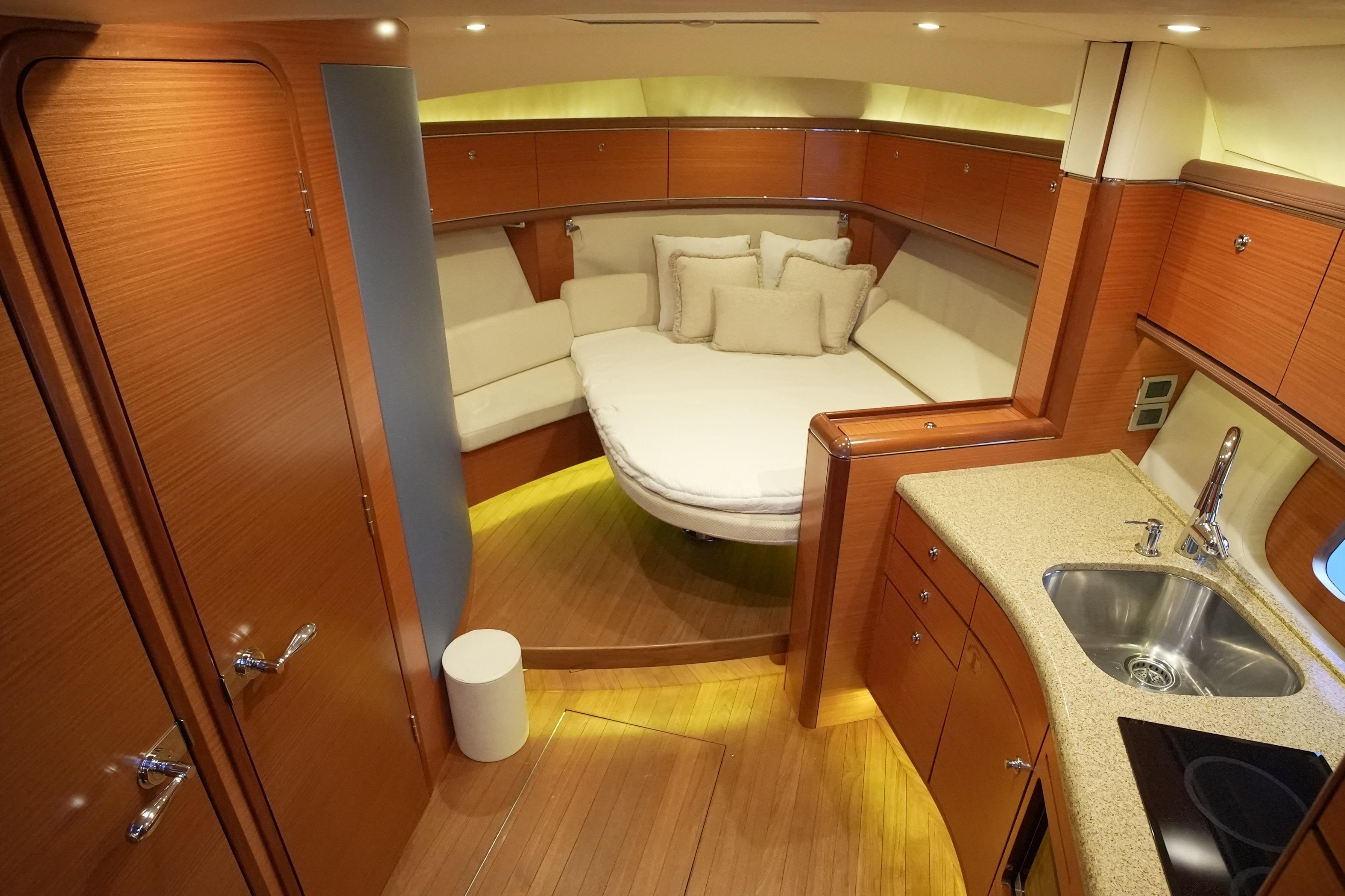 Luxurious 2013 Zeelander Z44 yacht interior with cozy seating and modern kitchenette.