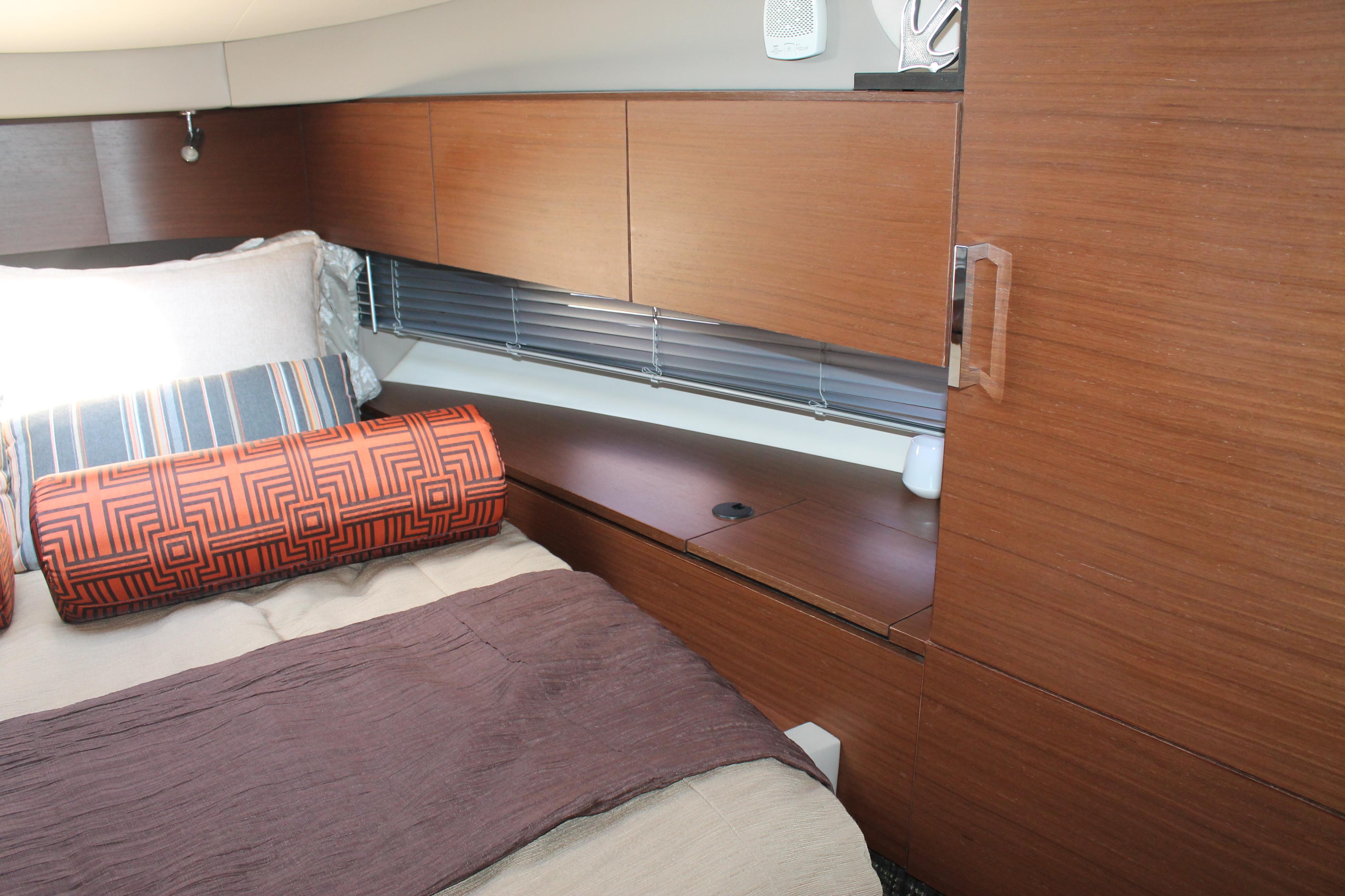 Luxurious cabin interior of 2015 Sea Ray 470 Sundancer yacht with modern wood finish.