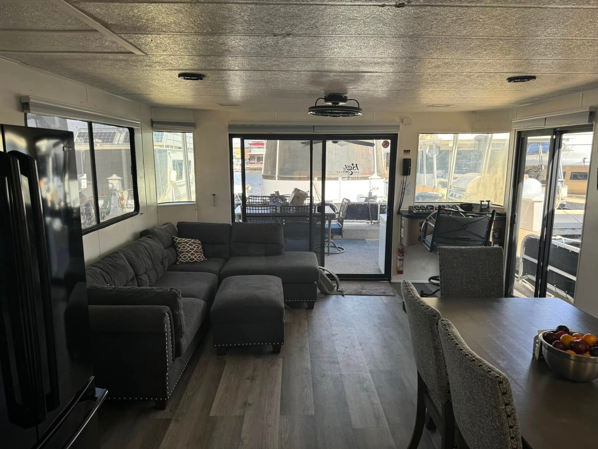 Interior of a 1993 Lakeview houseboat with sofa and dining table.