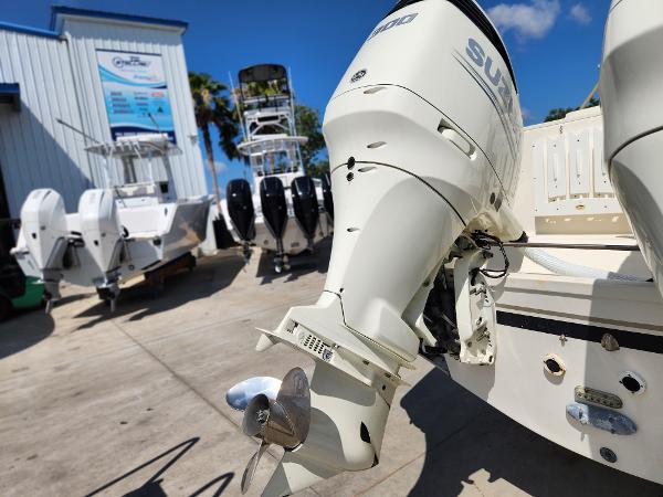 2005 Pursuit 3070 Offshore Center Console with Suzuki outboard motor in a boatyard.