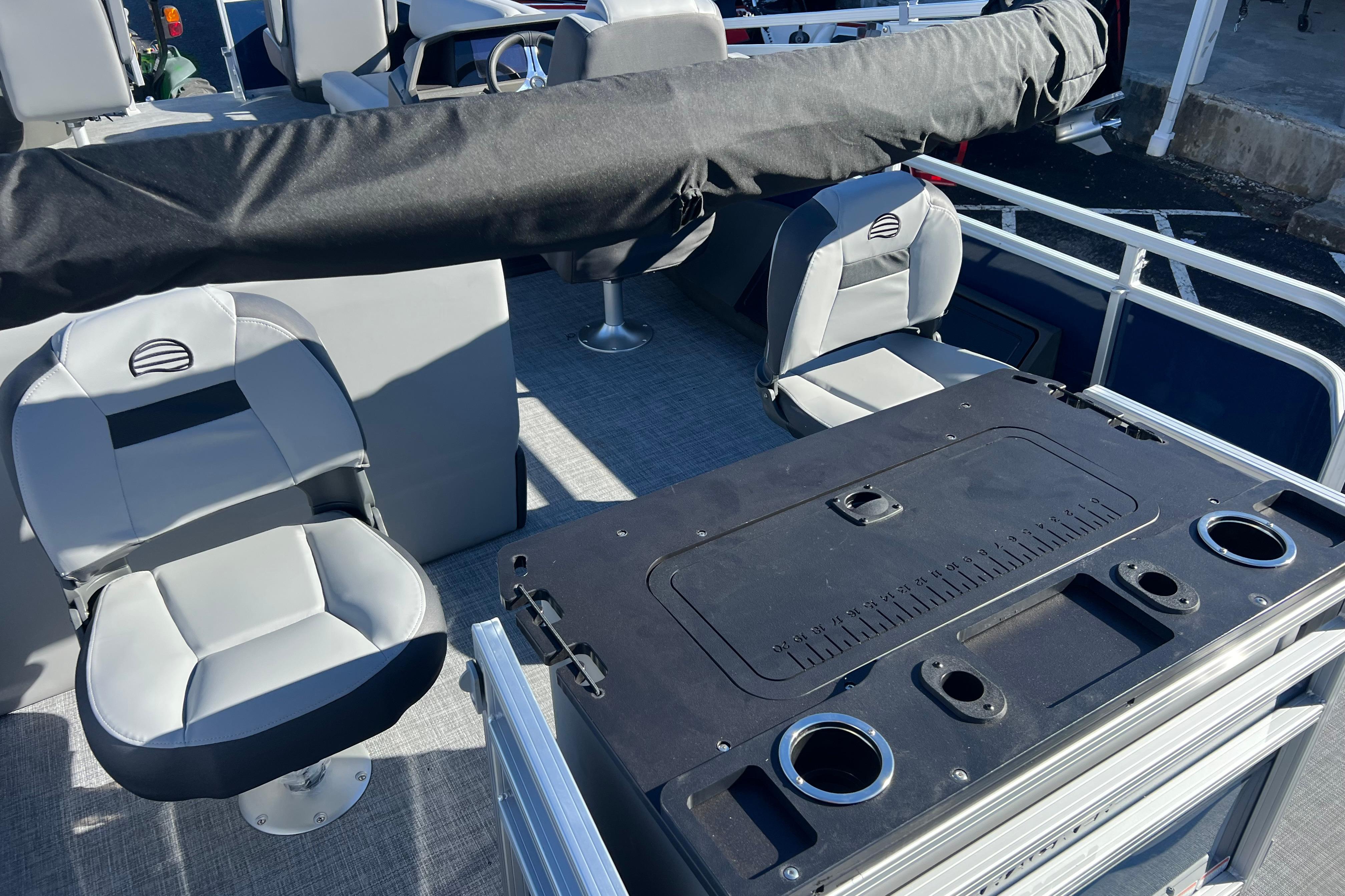 2026 Sun Tracker Sportfish 24 XP3 interior with seating and fishing station.