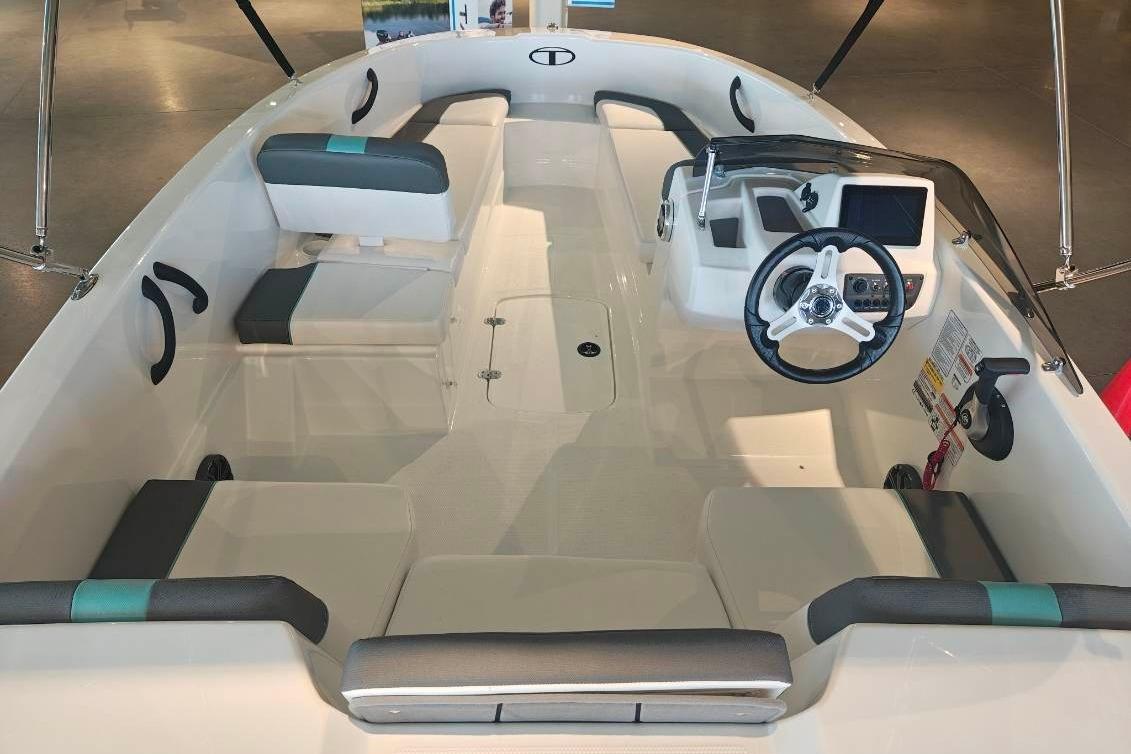 2026 Tahoe T16 boat interior with steering wheel, seating, and dashboard controls.