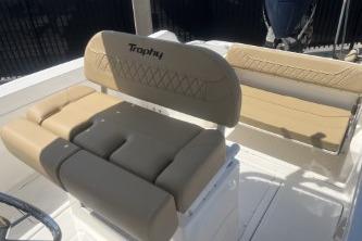 2023 Trophy T24 CC boat interior with beige seating and steering wheel.