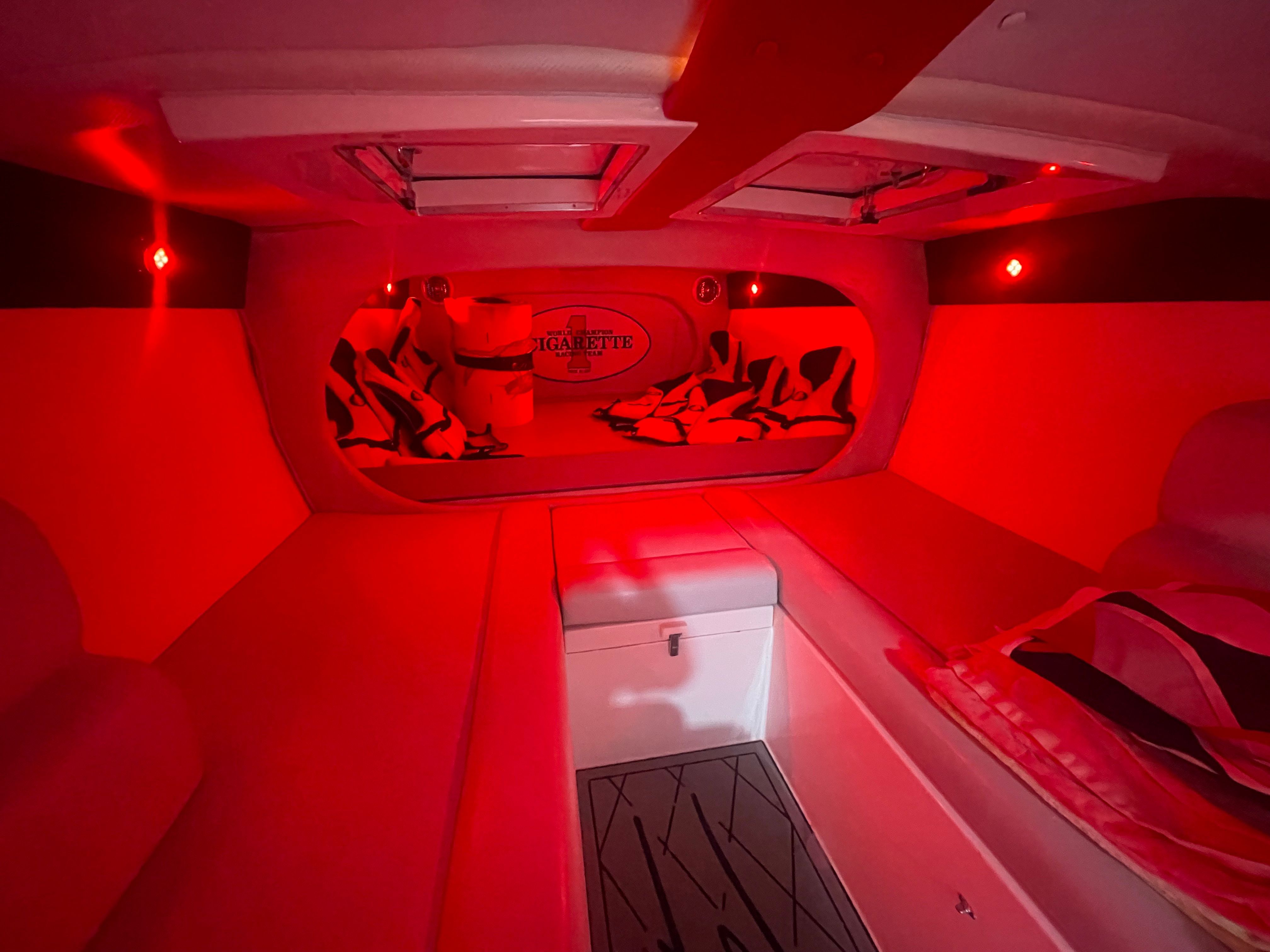 Interior of a 2004 Cigarette 38' Top Gun boat with red lighting.