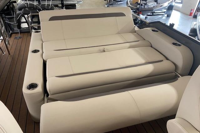 2026 Bentley Pontoons Legacy 223 Swingback with luxurious beige seating and cup holders.