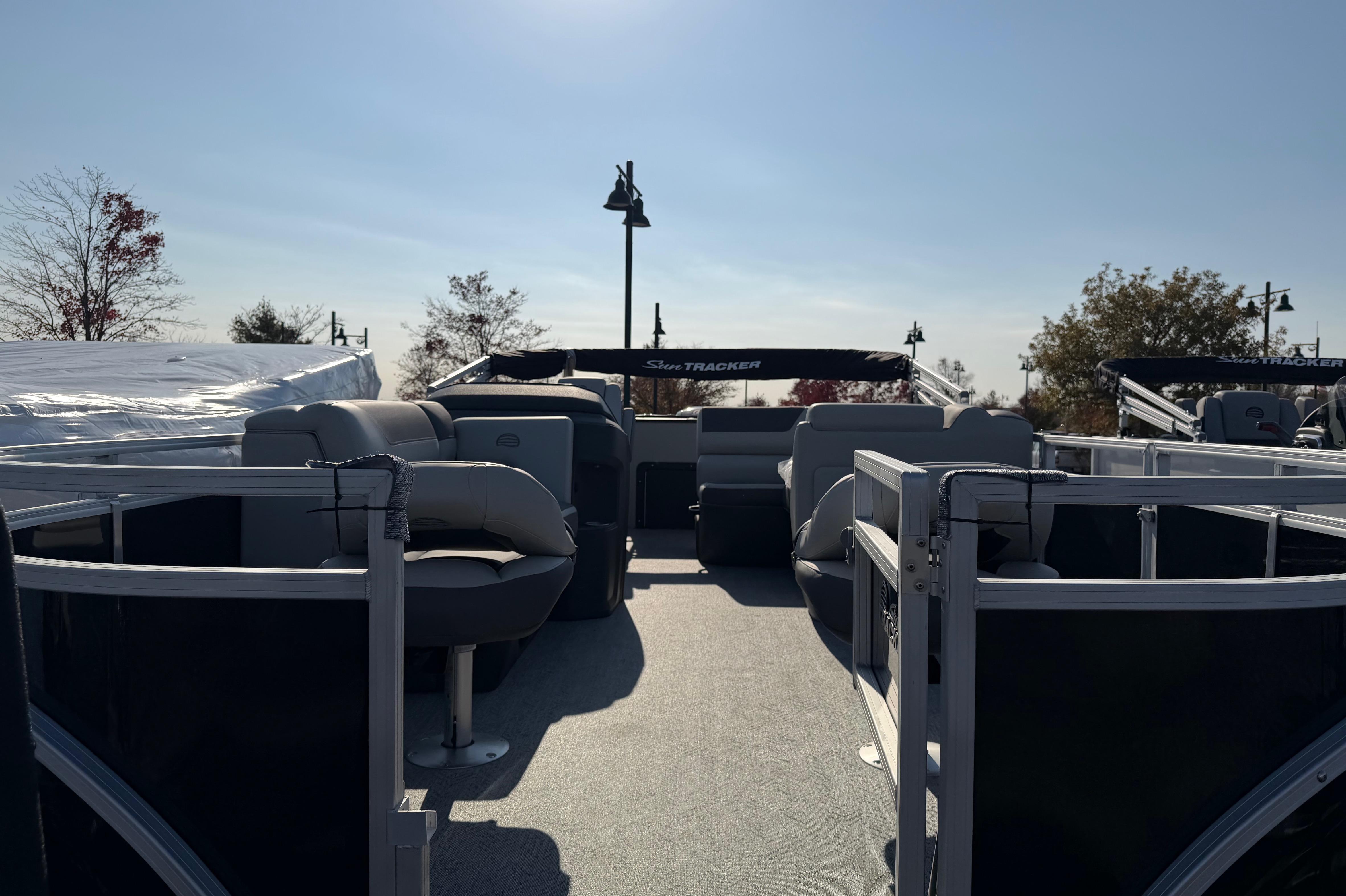 2026 Sun Tracker Fishin' Barge 20 DLX pontoon boat with spacious seating and open deck.
