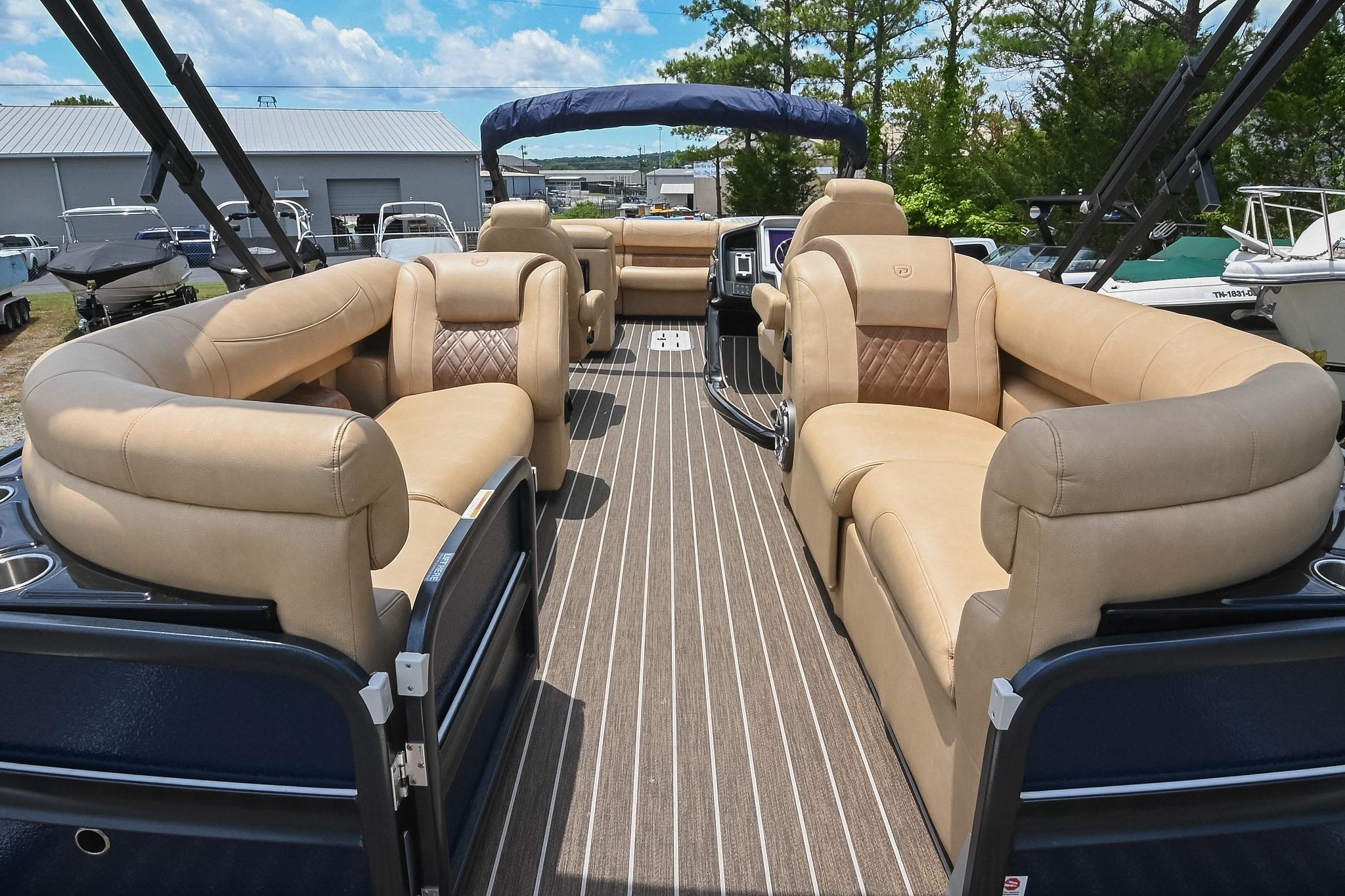 Luxurious interior of 2023 Premier 270 Intrigue RF pontoon boat with plush seating.