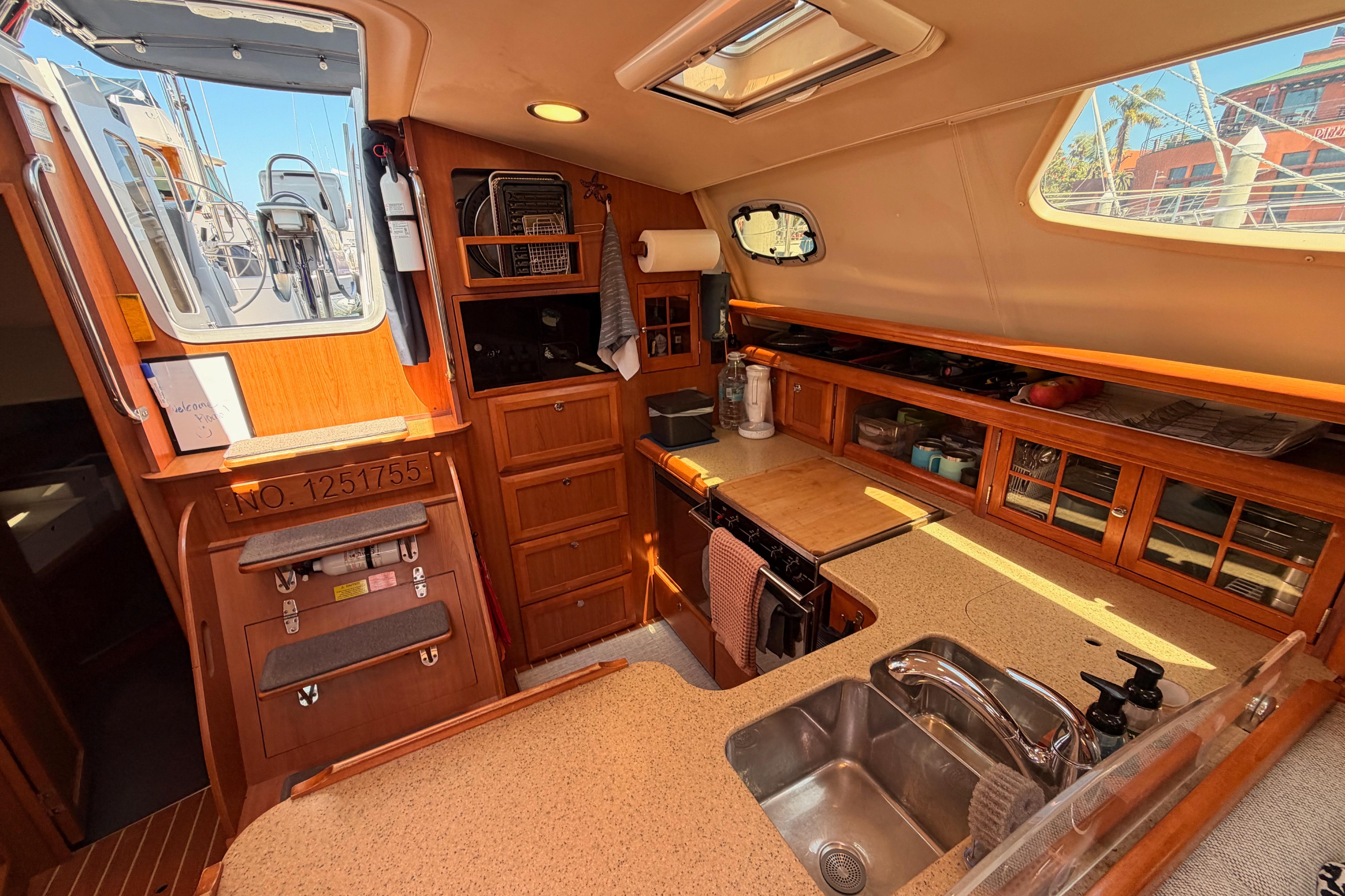 Interior of 2008 Hunter 45 Deck Salon yacht, featuring a well-equipped kitchen area.