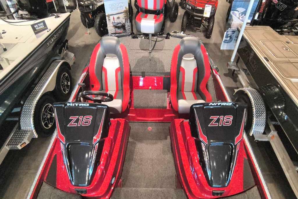 2026 Nitro Z18 Pro boat with dual seats, red and black design, displayed indoors.