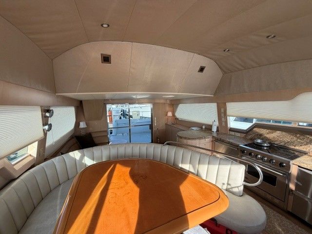 Interior of a 1990 custom motor yacht with kitchen and seating area.