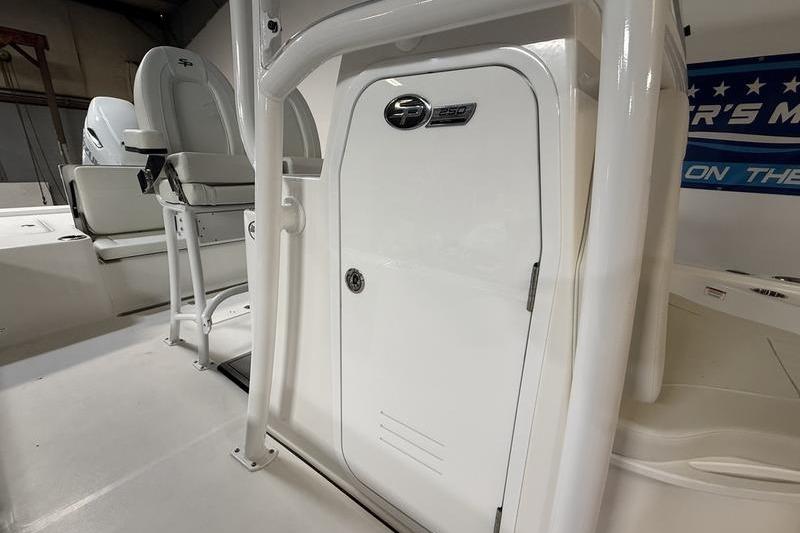 2026 Sea Pro 250 Bay boat interior with seating and storage compartment.