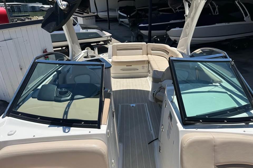 2012 Chaparral 284 Sunesta boat interior with beige seating and open deck layout.