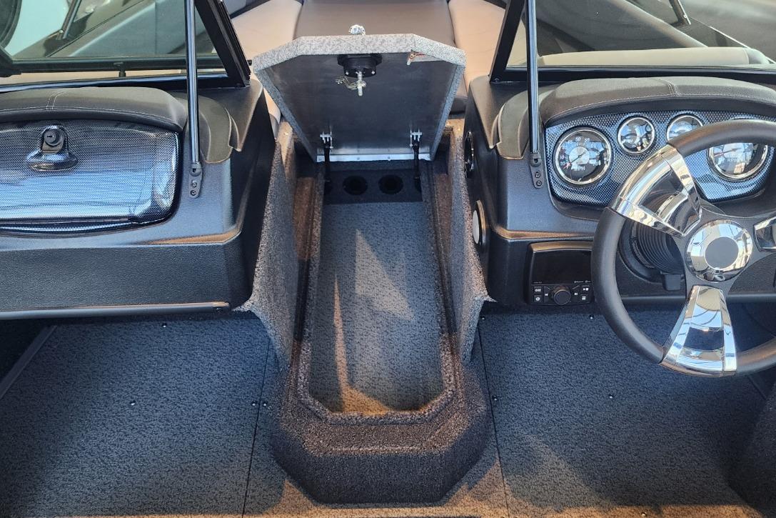 2023 Lowe boat interior with steering wheel, dashboard, and open storage compartment.