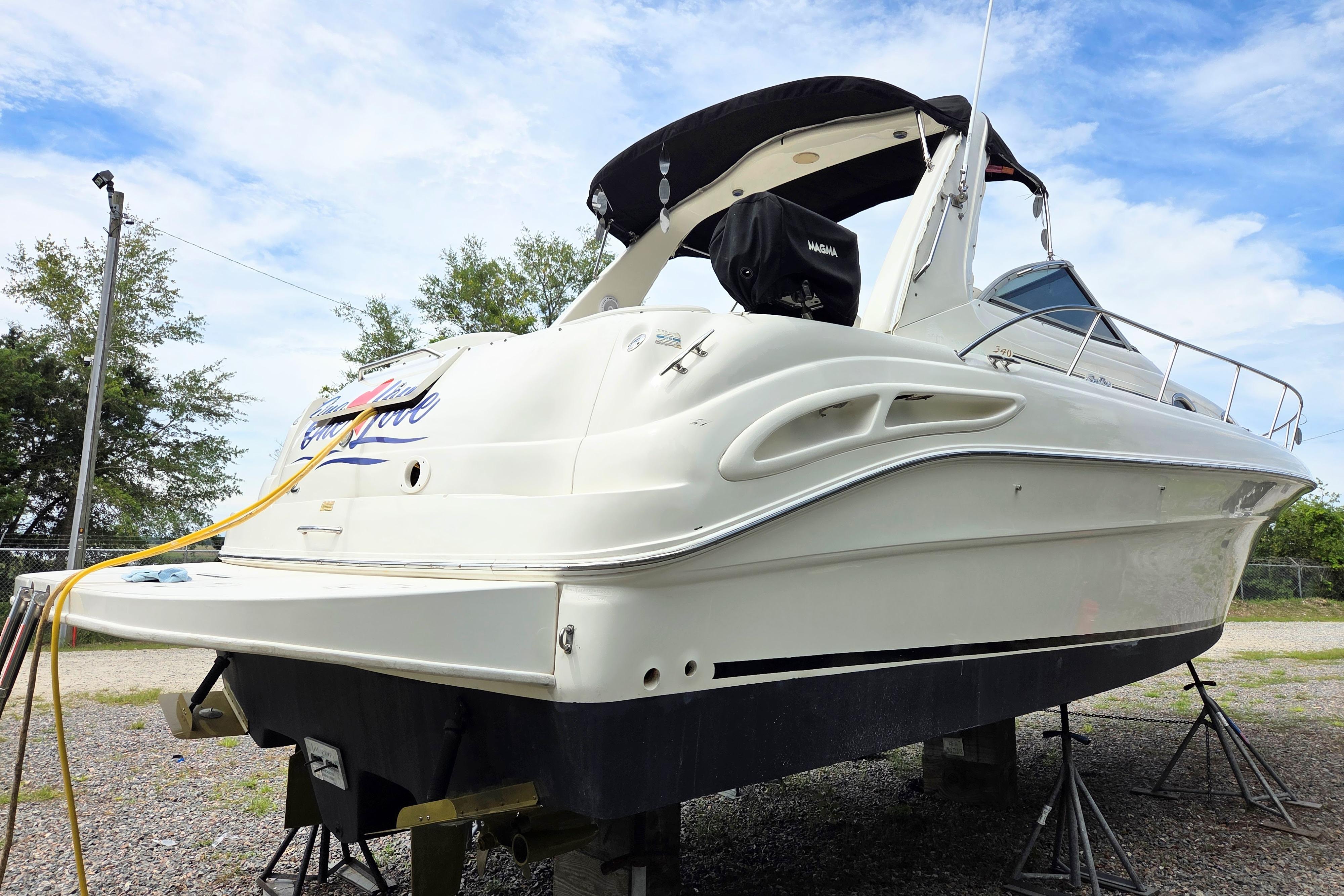 2000 Sea Ray 340 Sundancer boat on stands, white hull, outdoor setting.
