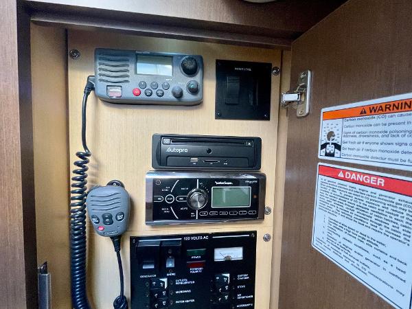 Control panel of 2014 Sea Ray 330 Sundancer with radio and warning labels.