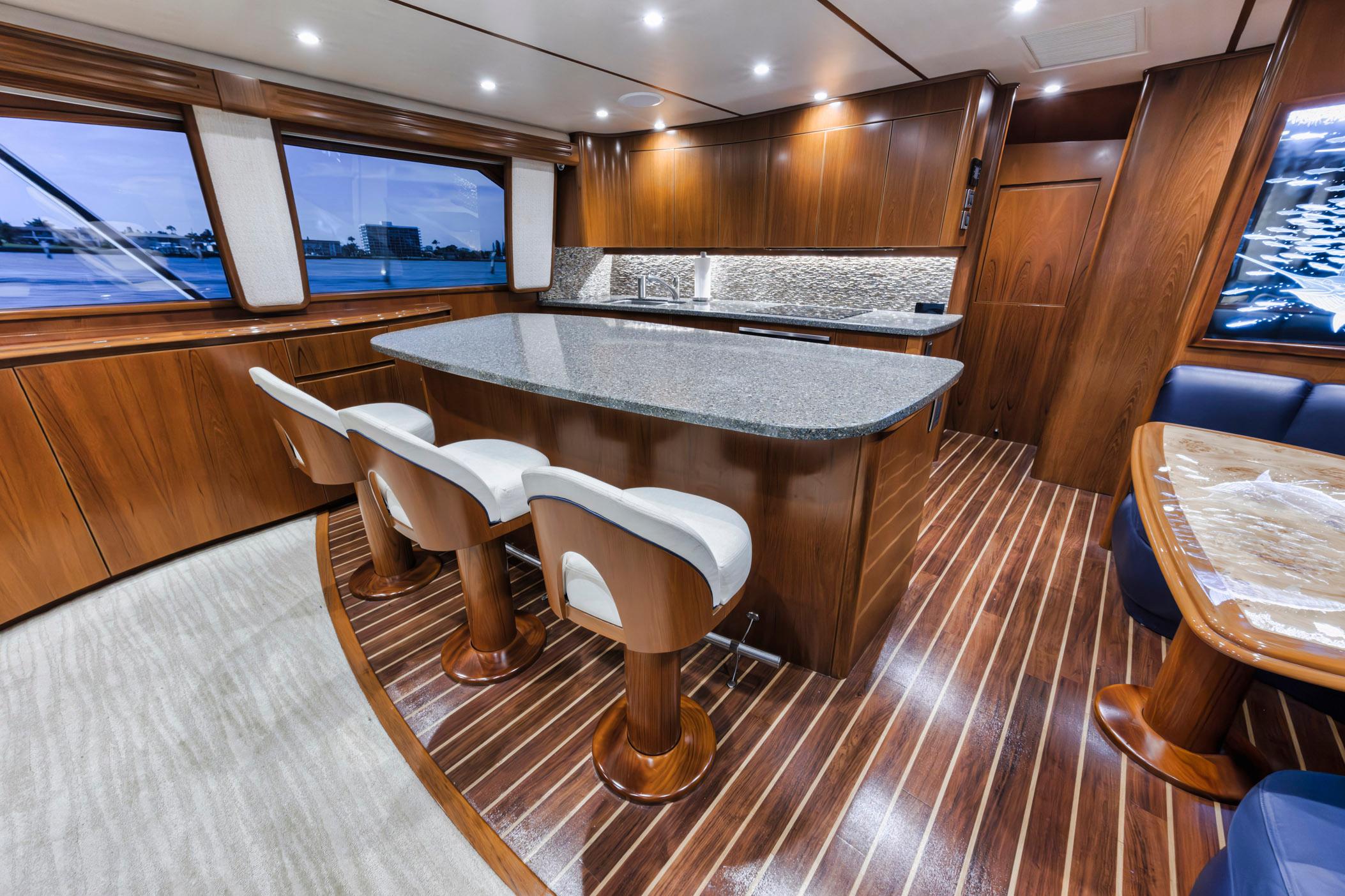 Luxurious interior of 2015 Viking 70 Convertible yacht with elegant wood finishes and modern design.
