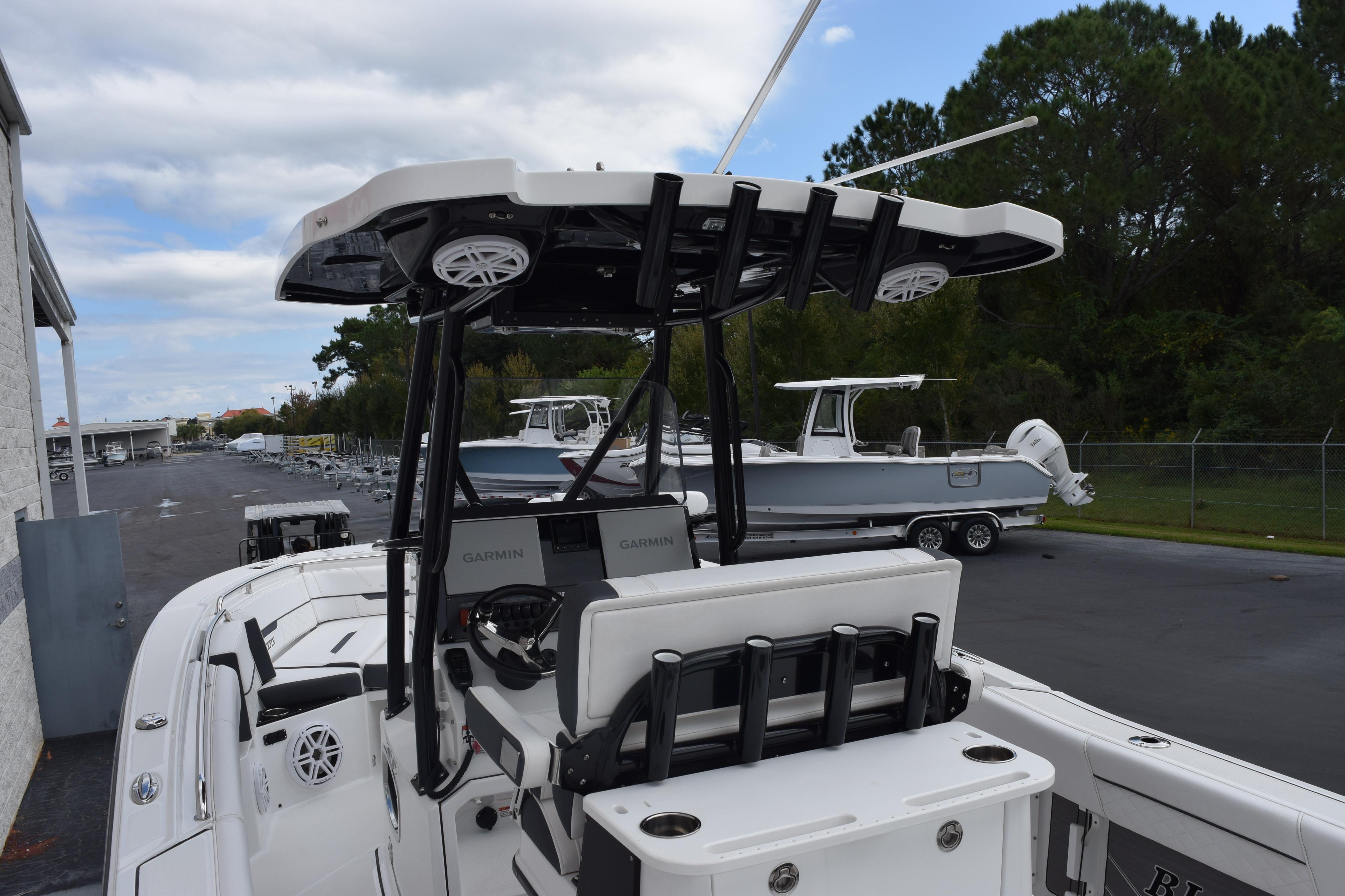 2023 Blackfin 252 CC boat with advanced Garmin navigation, docked outdoors.