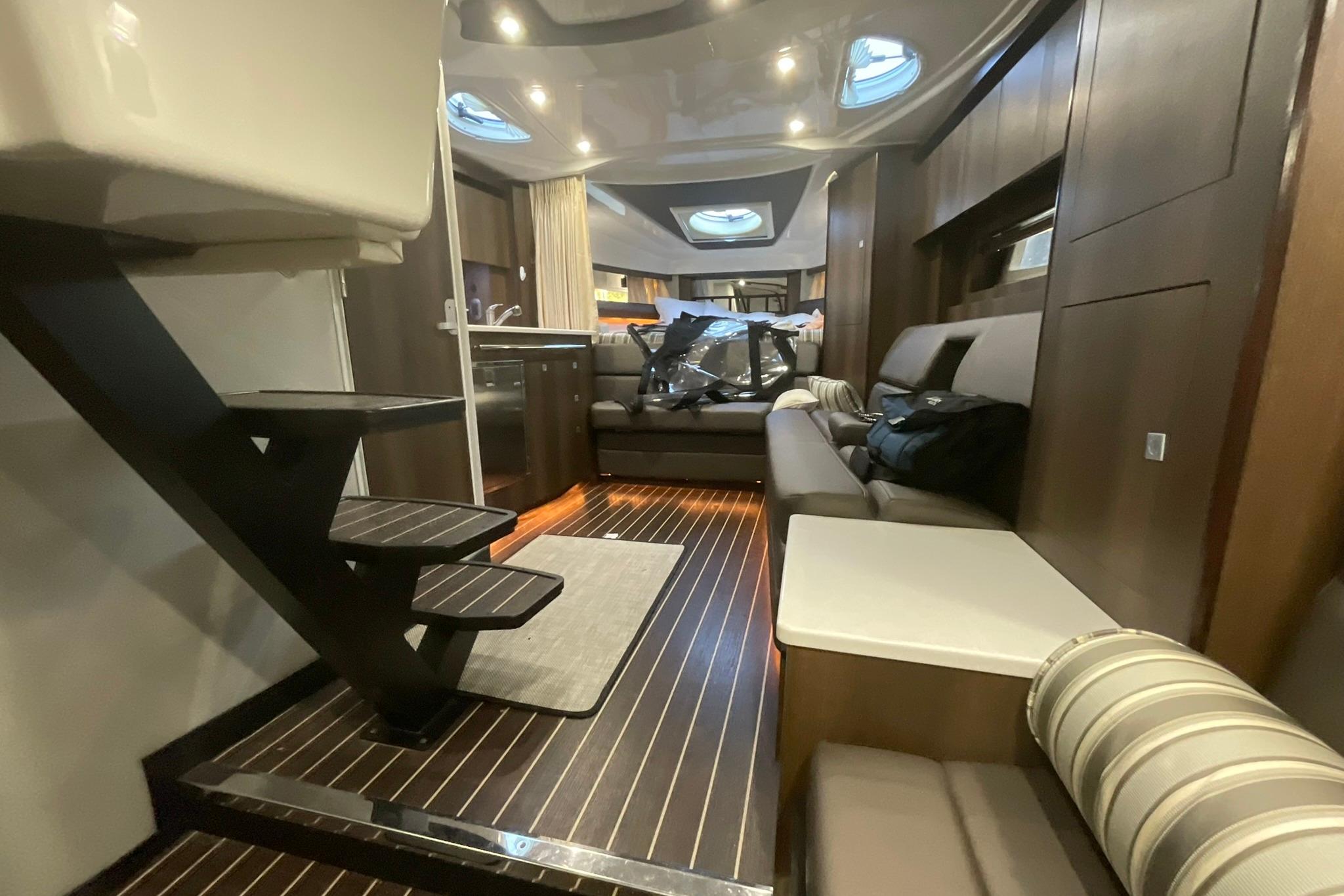 Luxurious interior of 2019 Monterey 335 Sport Yacht with modern furnishings and ambient lighting.
