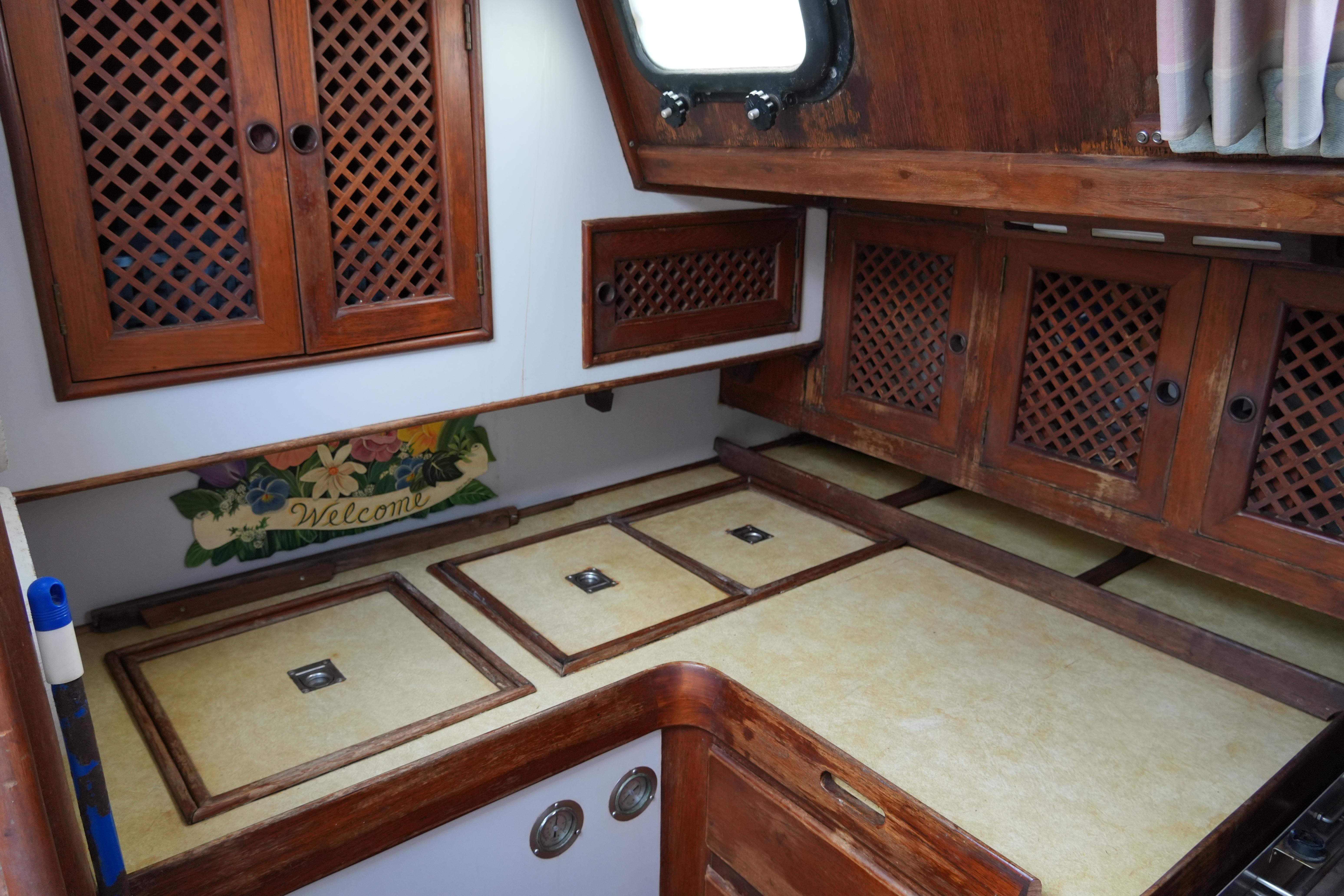 Interior of 1980 Lafitte 44 Cutter with wooden cabinets and countertop.