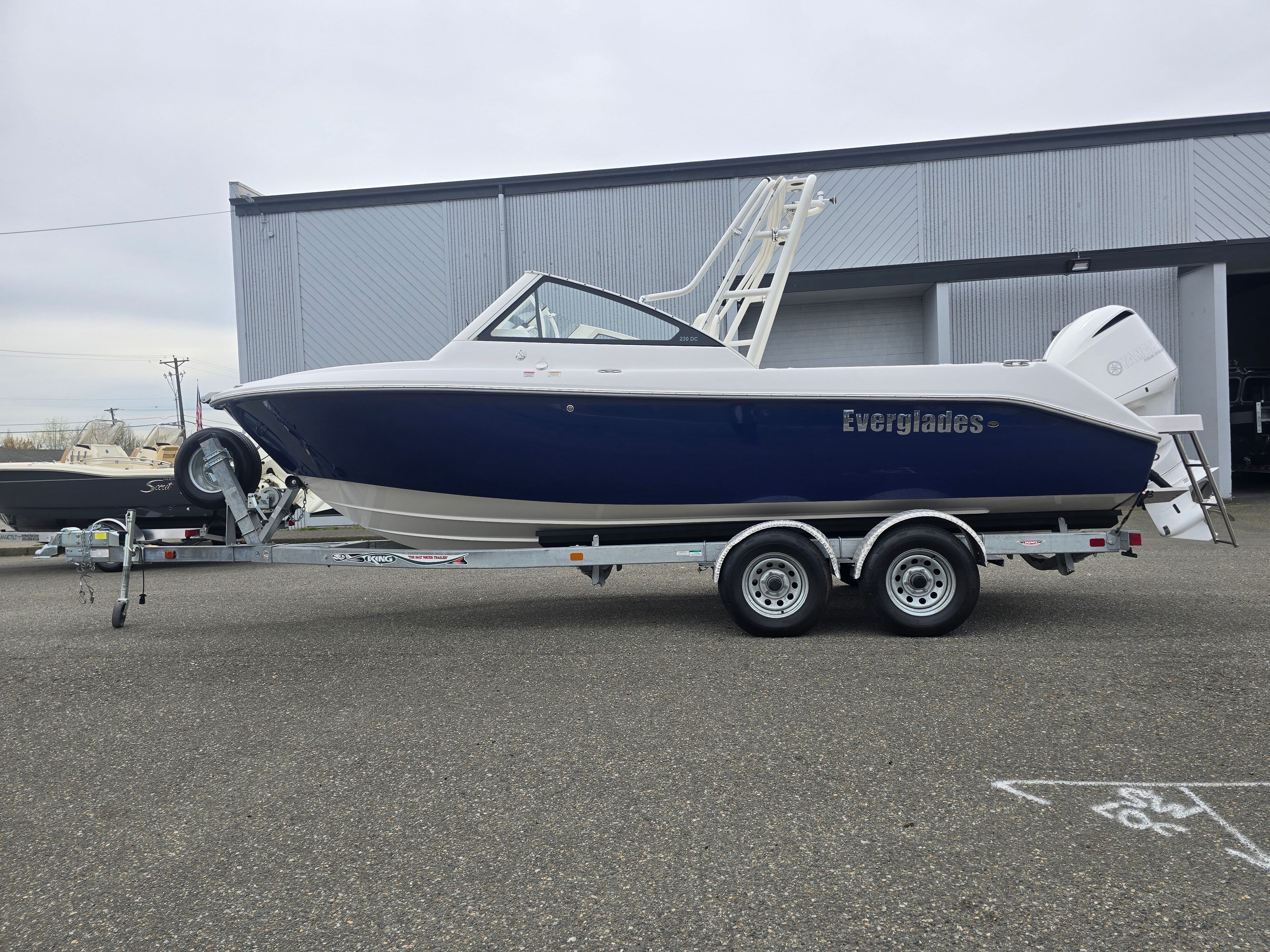 2017 Everglades 230 Dual Console on a trailer in front of a building.