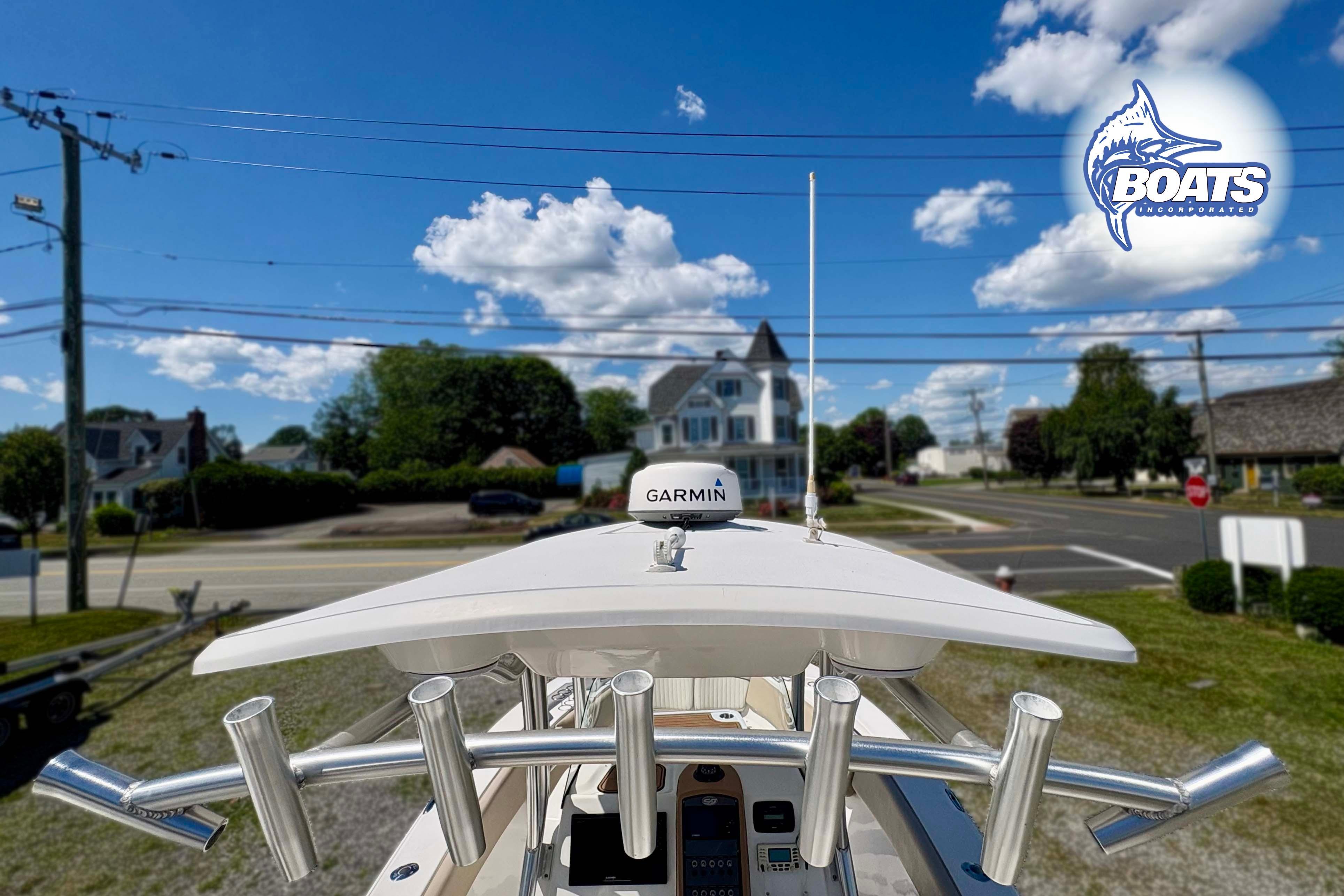 2015 Sea Fox 266 Commander boat with Garmin equipment, parked near a residential area under a blue sky.
