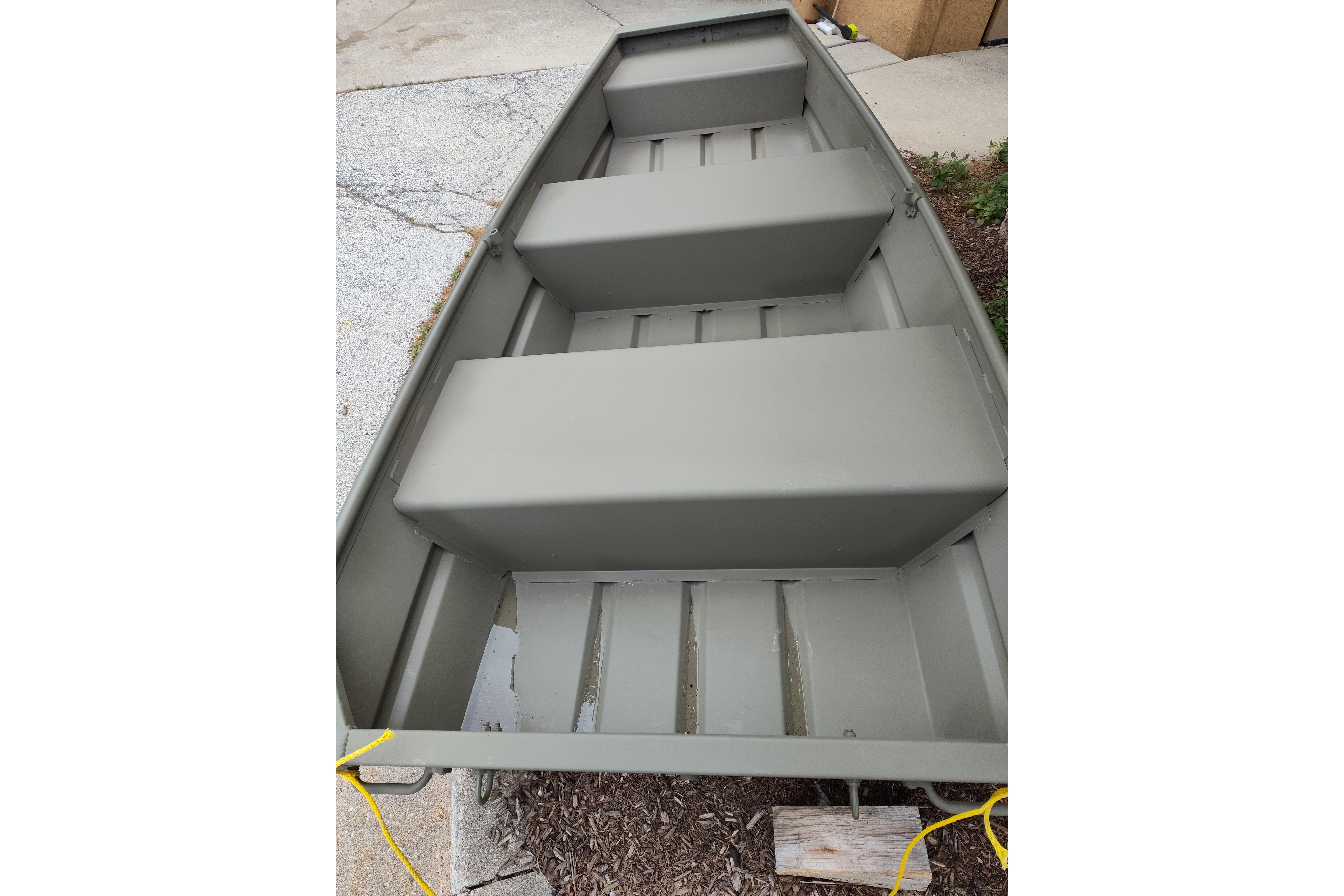 2025 Tracker Grizzly 1036 Utility boat, interior view, parked on concrete surface.