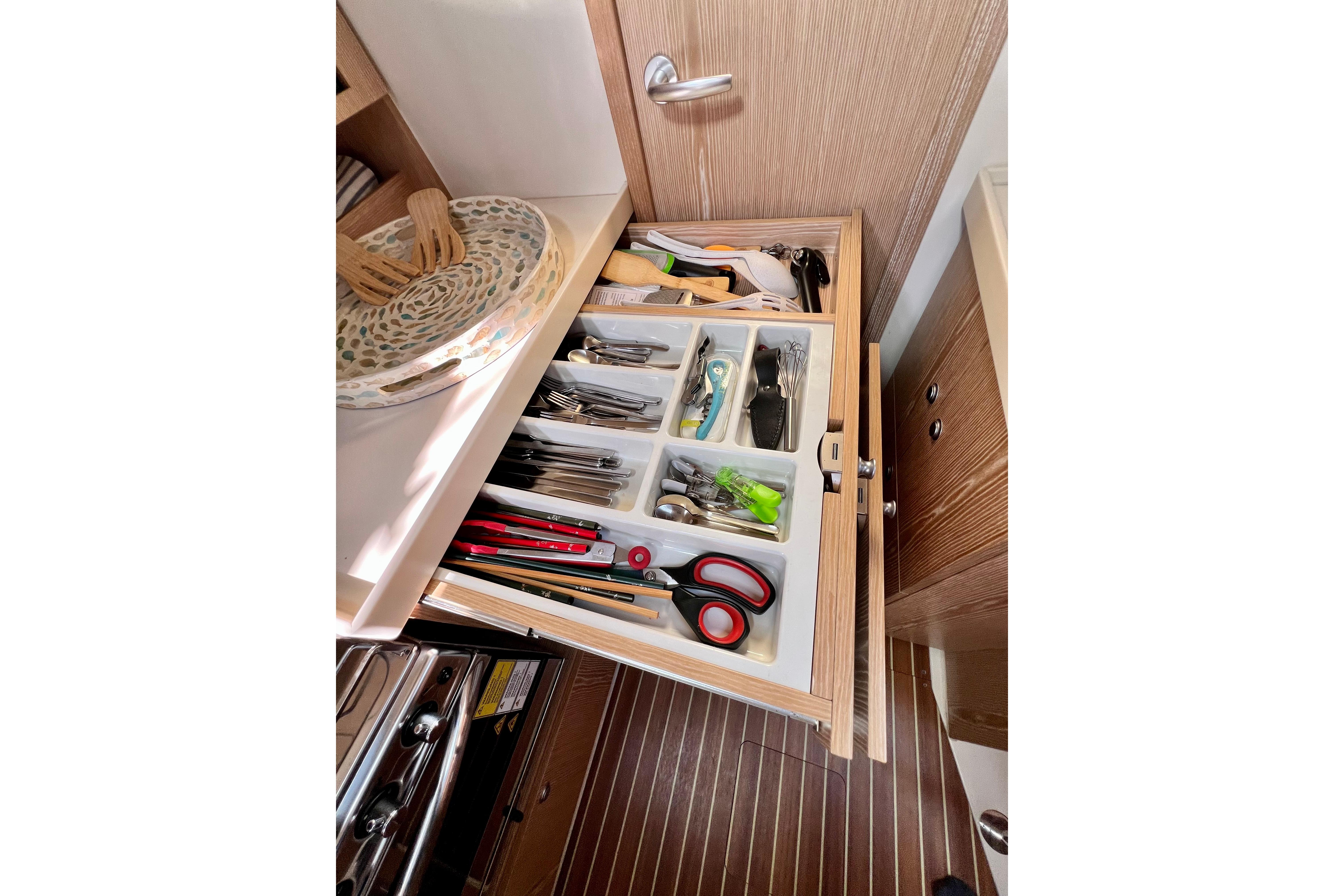 Open drawer with organized utensils and tools on a 2016 Hanse 455 yacht.