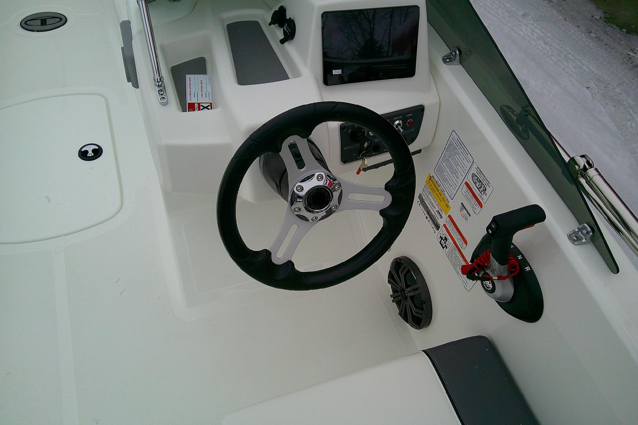 2026 Tahoe T18 boat cockpit with steering wheel and control panel.