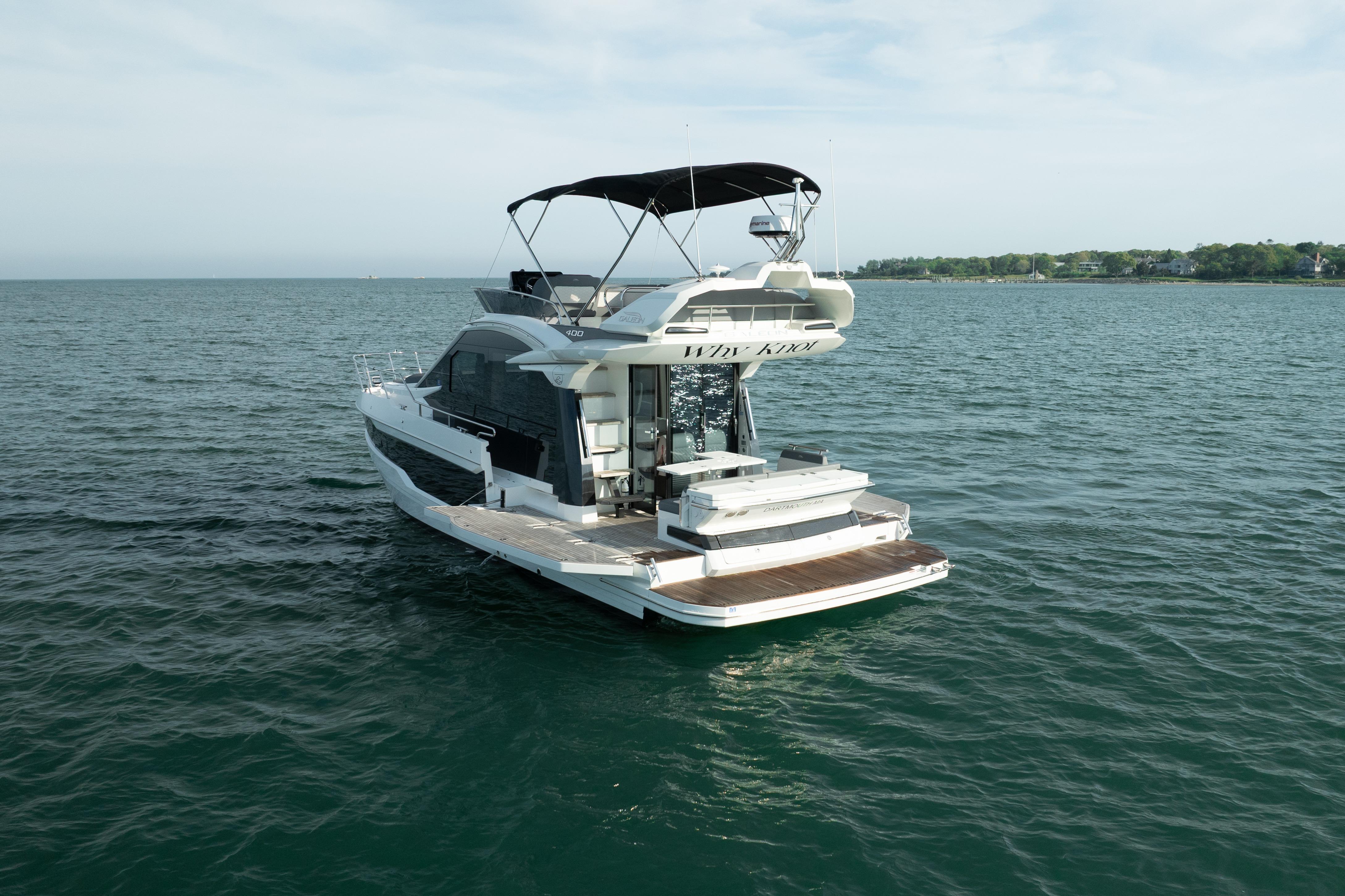 2023 Galeon 400 Fly yacht on open water, rear view with flybridge.