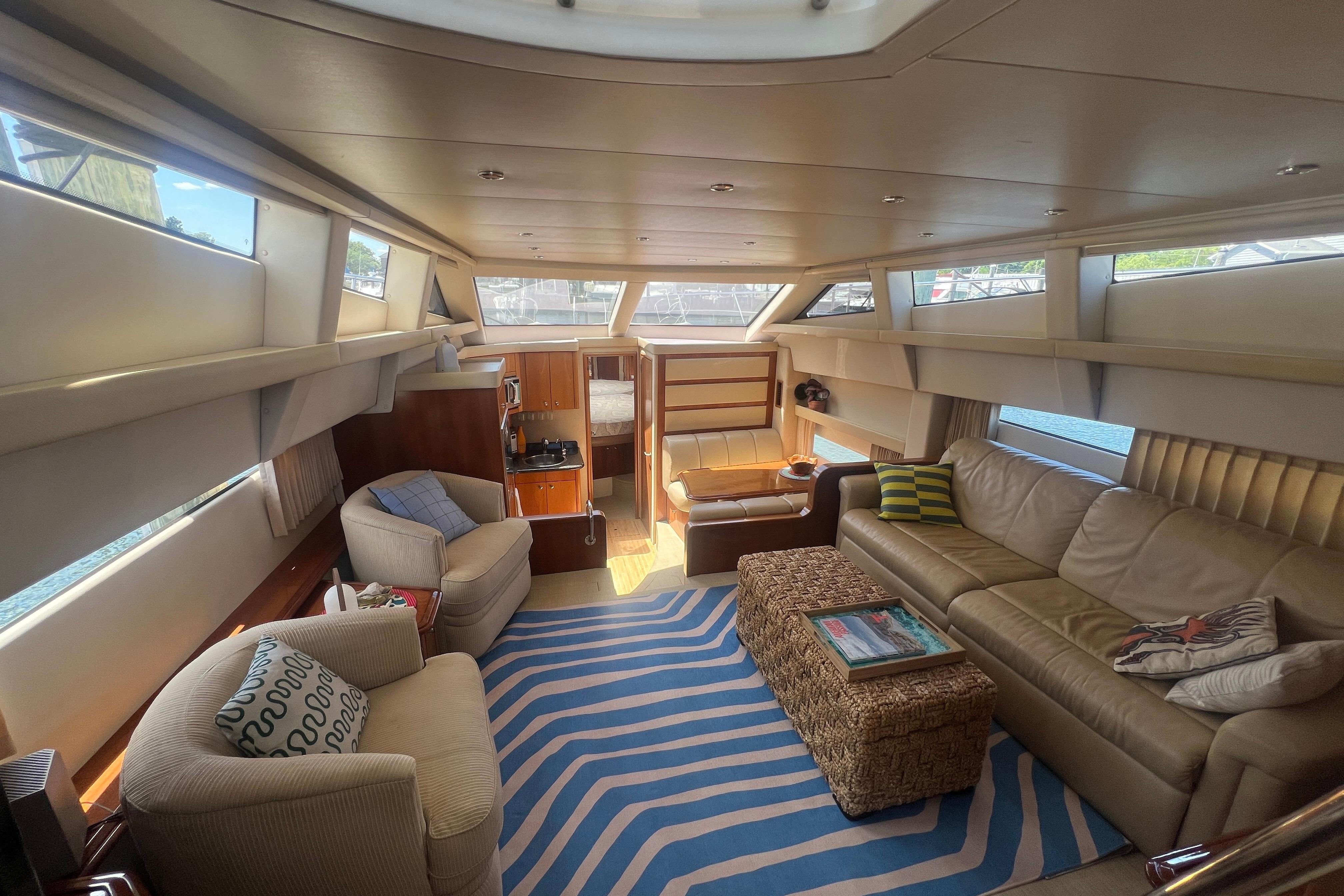 Luxurious interior of 2006 Carver 43 Motor Yacht with plush seating and natural light.