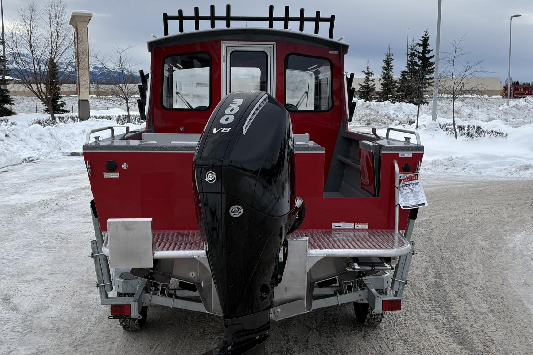 2024 Spartan 240 Maximus Pro boat with powerful outboard motor in snowy setting.