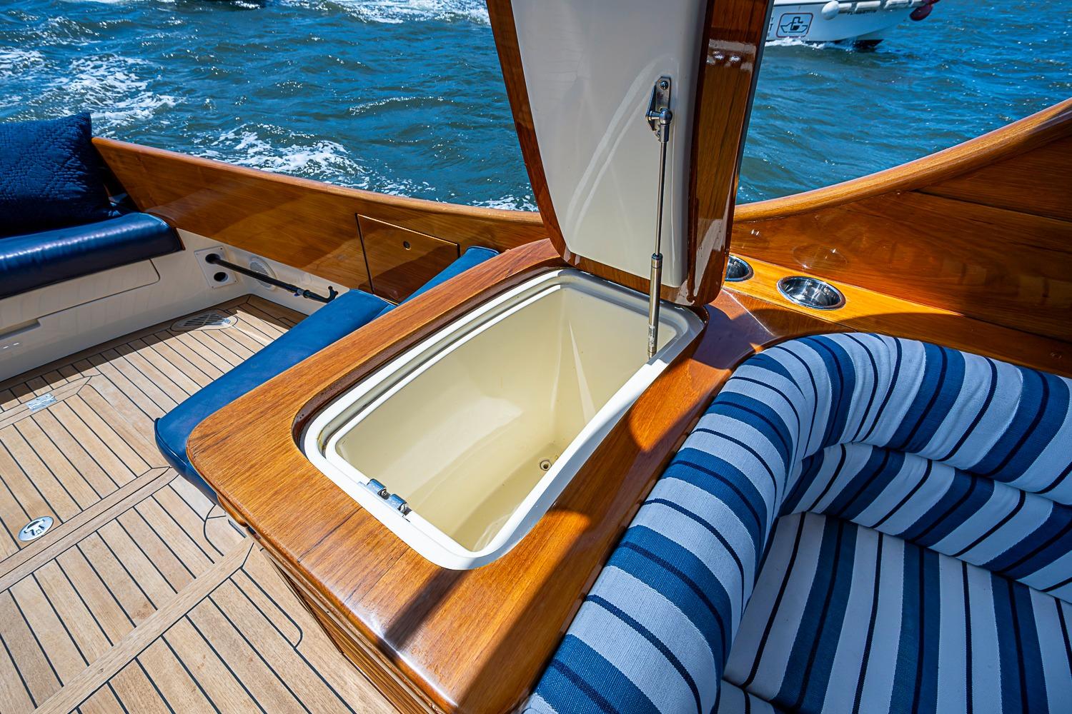 Luxurious 2013 Hinckley Picnic Boat 37 MKIII with elegant wood finish and striped seating.