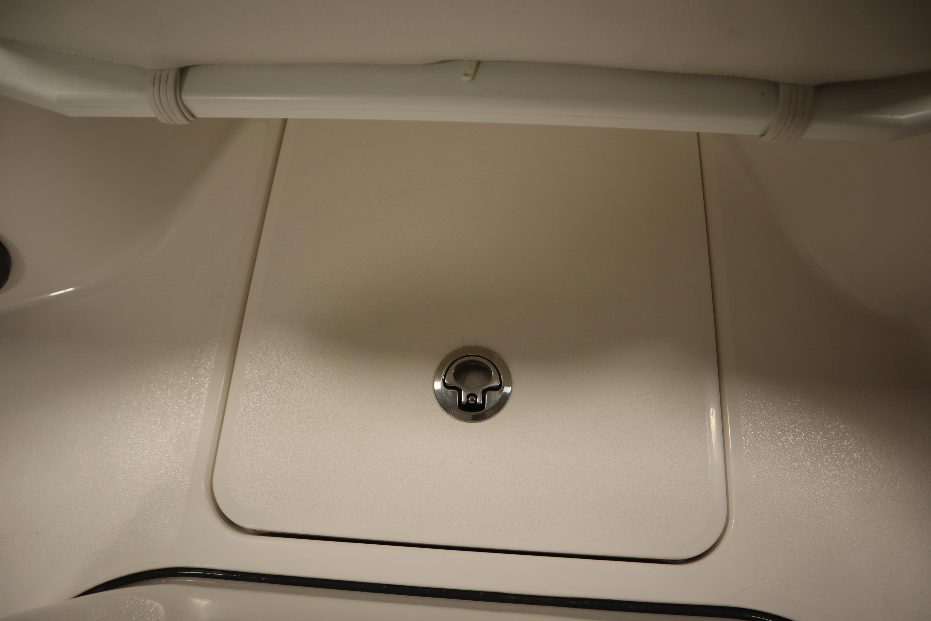 2026 Sea Fox 228 Commander boat storage compartment with secure latch.