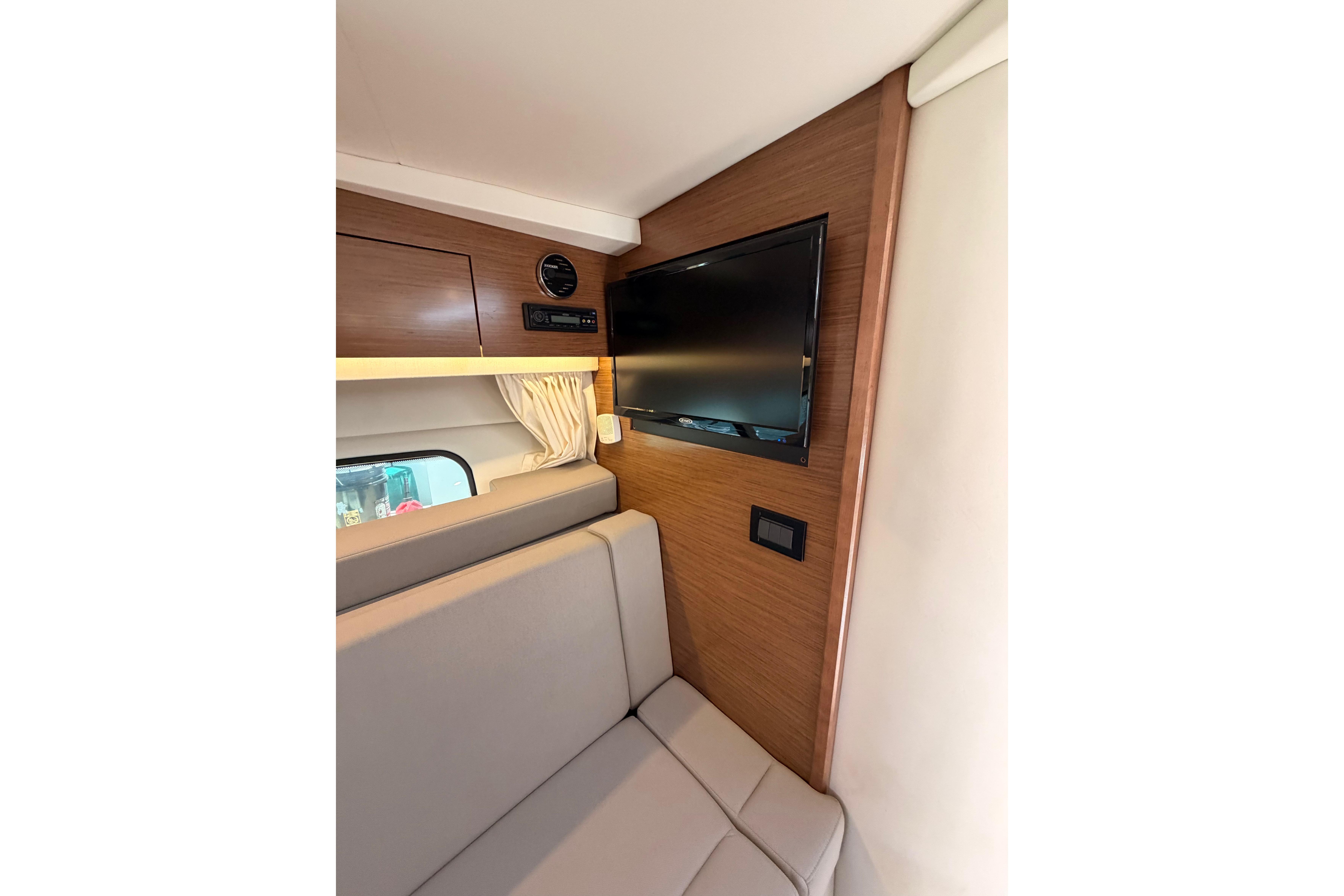 Interior of 2020 Cruisers Yachts 390 Express Coupe with TV and seating area.