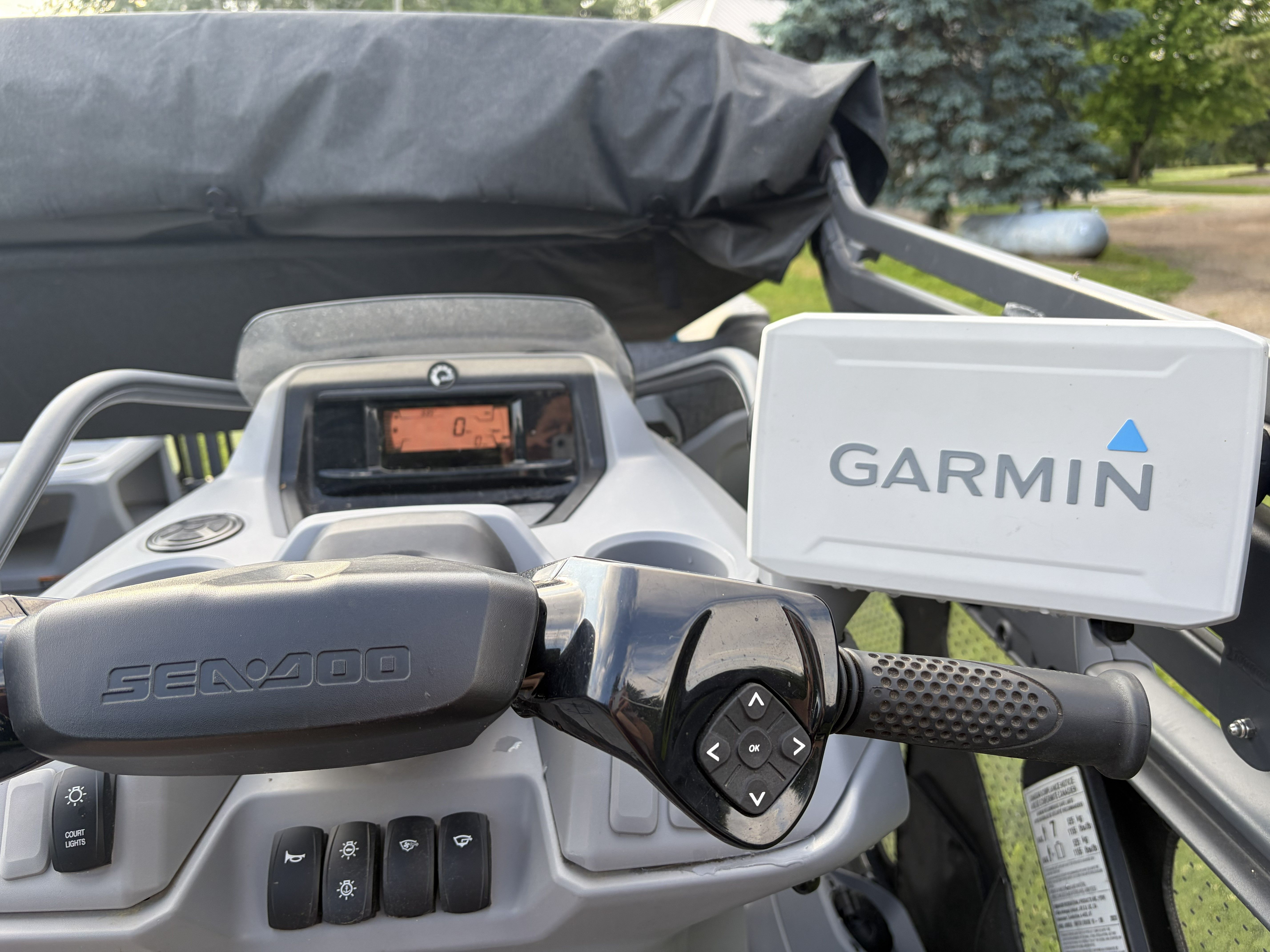 The image shows the cockpit of a Sea Doo Switch with a Garmin navigation system.