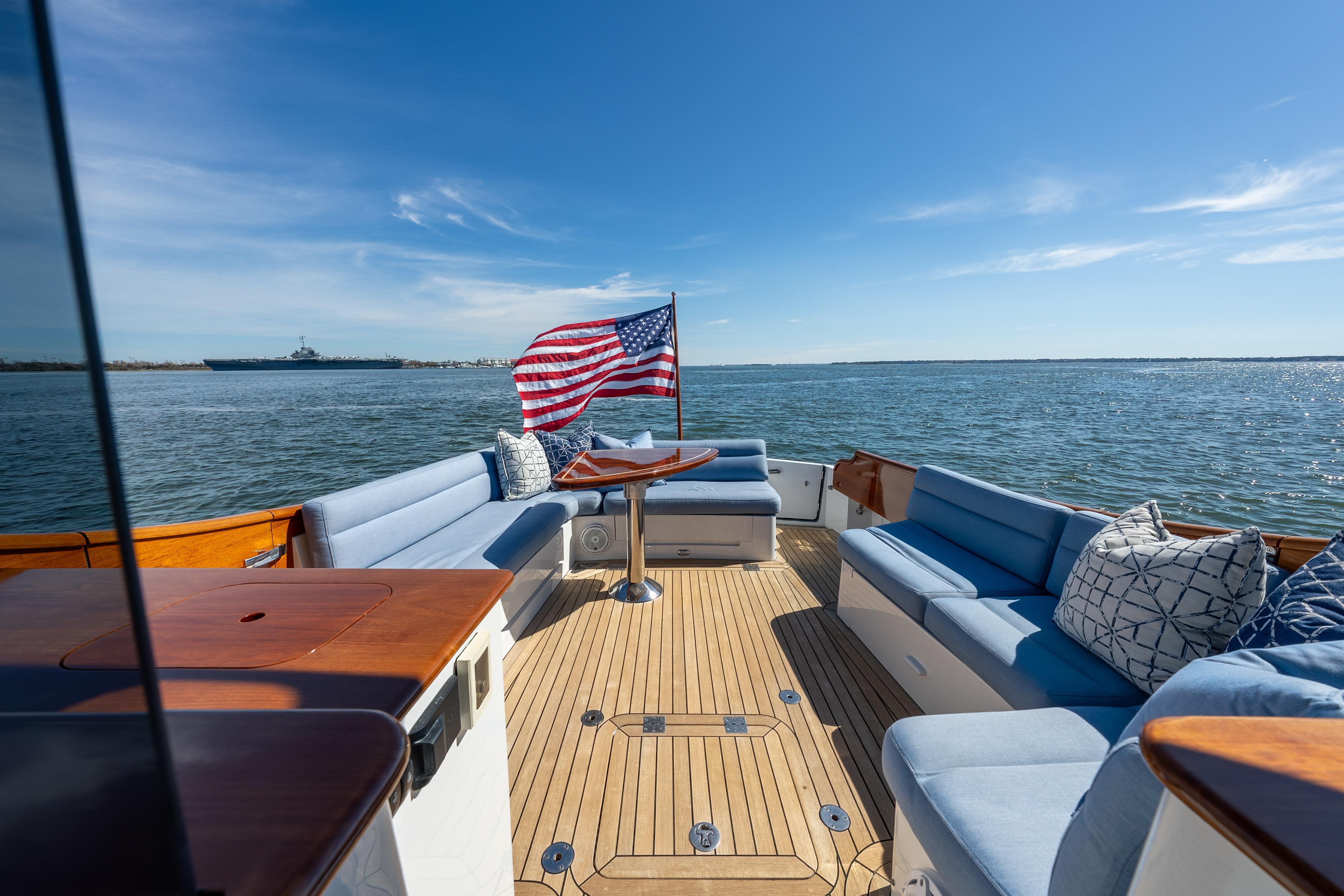 Hinckley Talaria 43 yacht deck with seating, American flag, and ocean view, 2015 model.