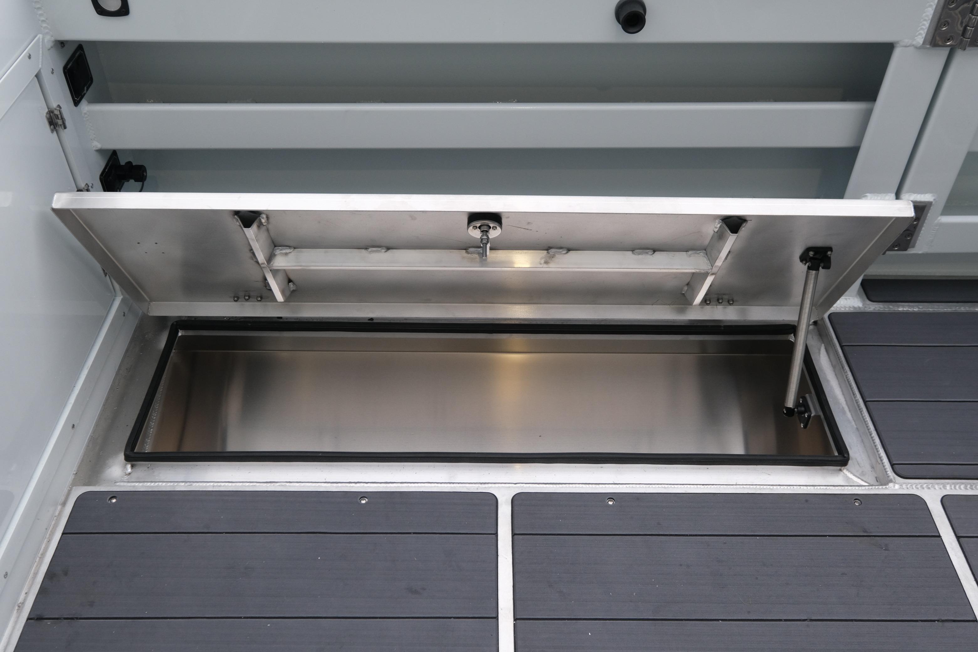 Open storage compartment on 2026 Hewescraft 270 Pacific Explorer boat.