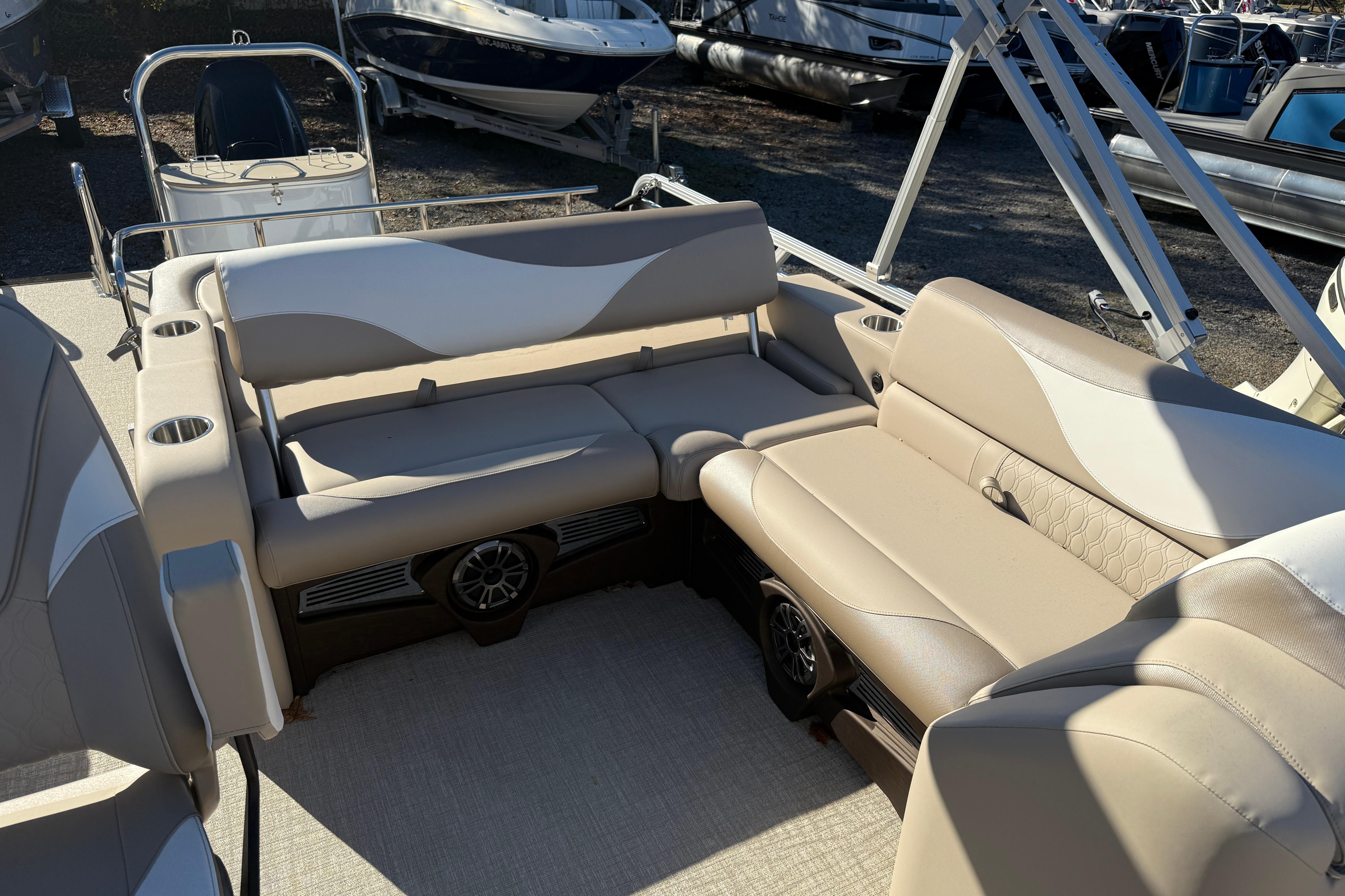 2026 Tahoe Pontoon LTZ Versatile Rear Lounger with beige seating and cup holders.
