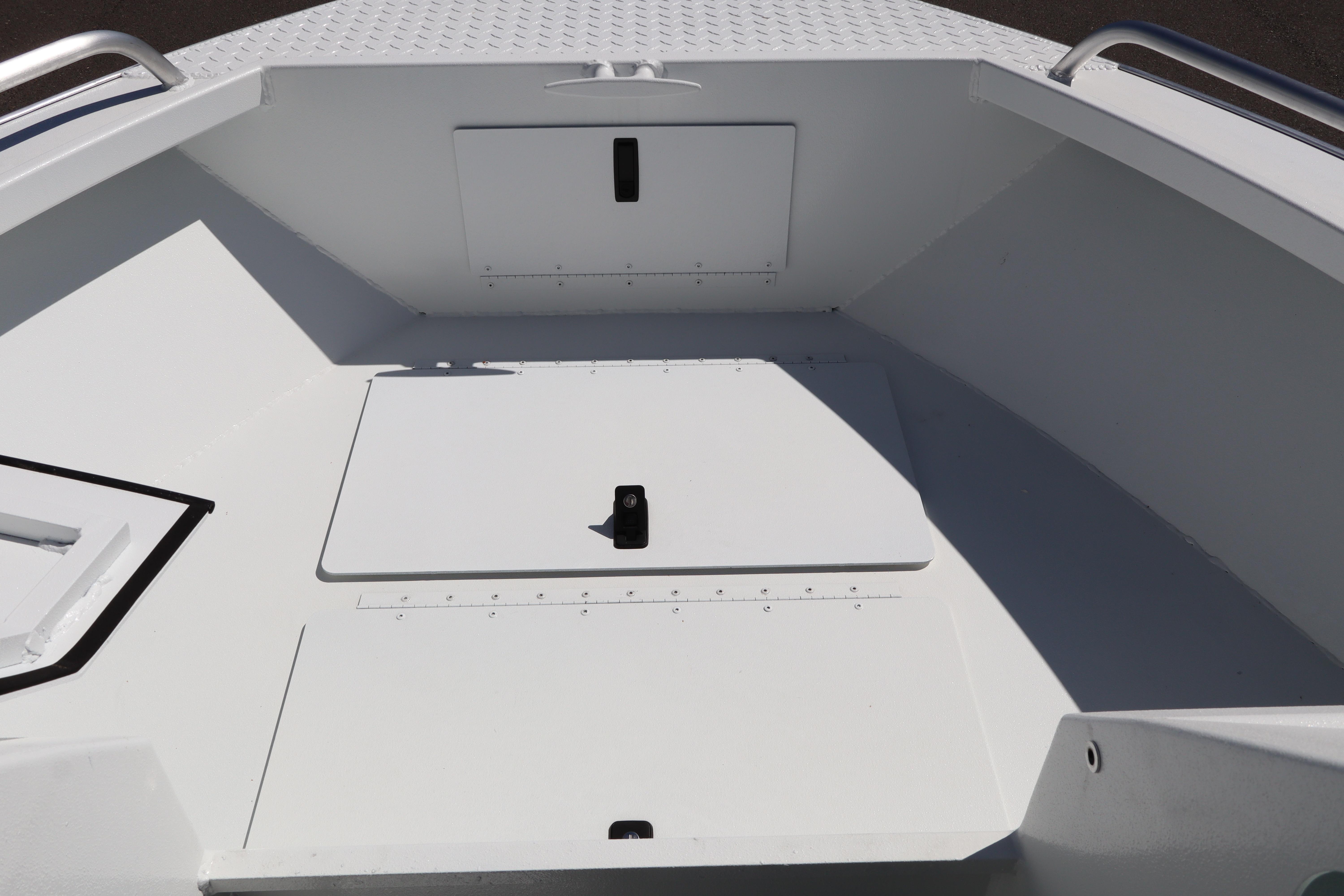 2026 Alumaweld Stryker 202 boat interior with storage compartments and metal railings.