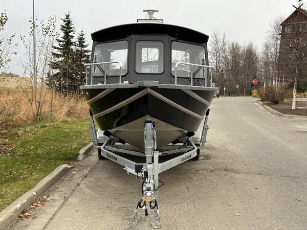 2024 Spartan 220 Maximus boat on trailer, parked on a road.