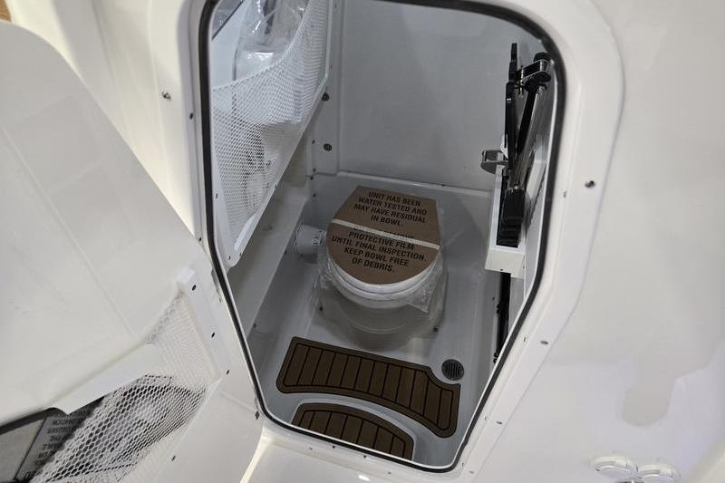 2026 Sea Hunt Ultra 275 Coffin Box boat interior with compact marine toilet.