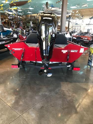 2025 Tracker Pro Team 175 boat, red exterior, displayed indoors with motor visible.