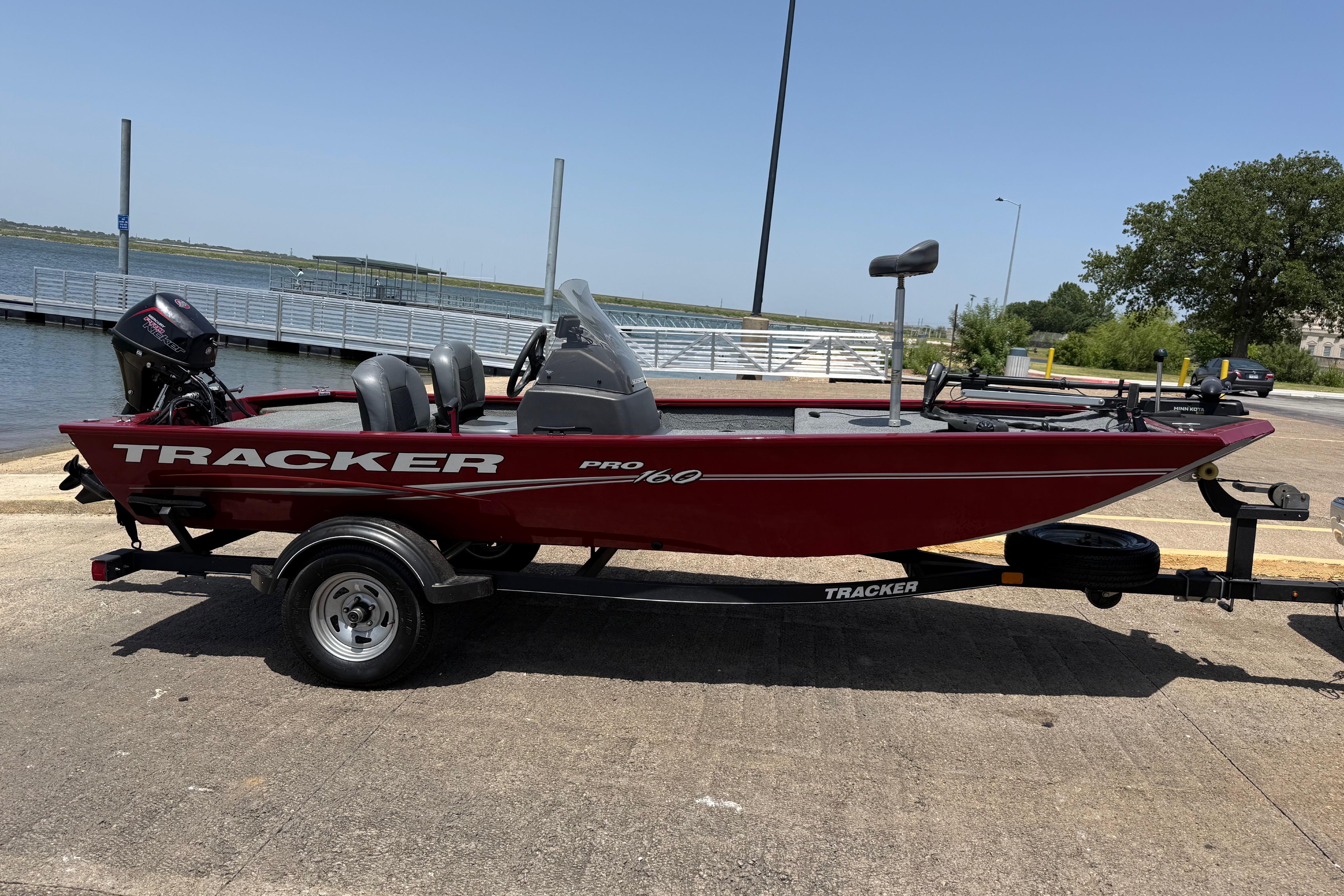 2019 Tracker Pro 160 boat on trailer near a lakeside dock.