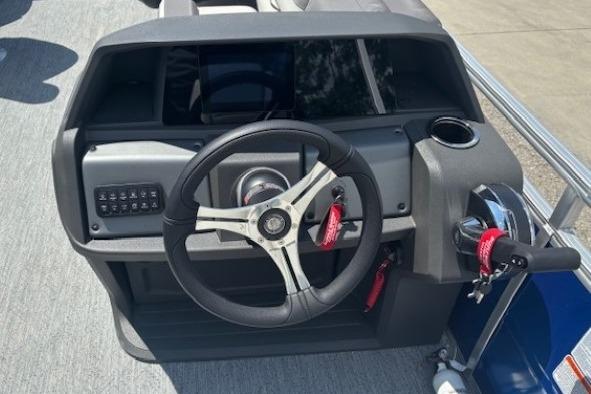 2026 Sun Tracker Fishin' Barge 20 DLX steering console with modern controls and cup holder.