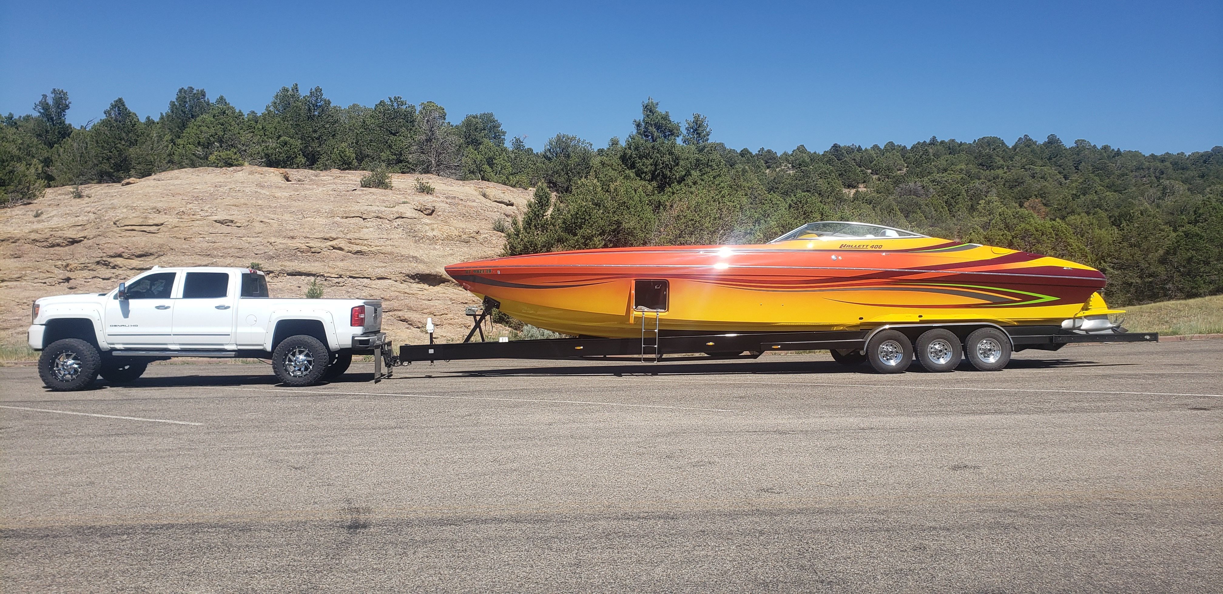 2009 Hallett 400T boat on trailer with pickup truck.