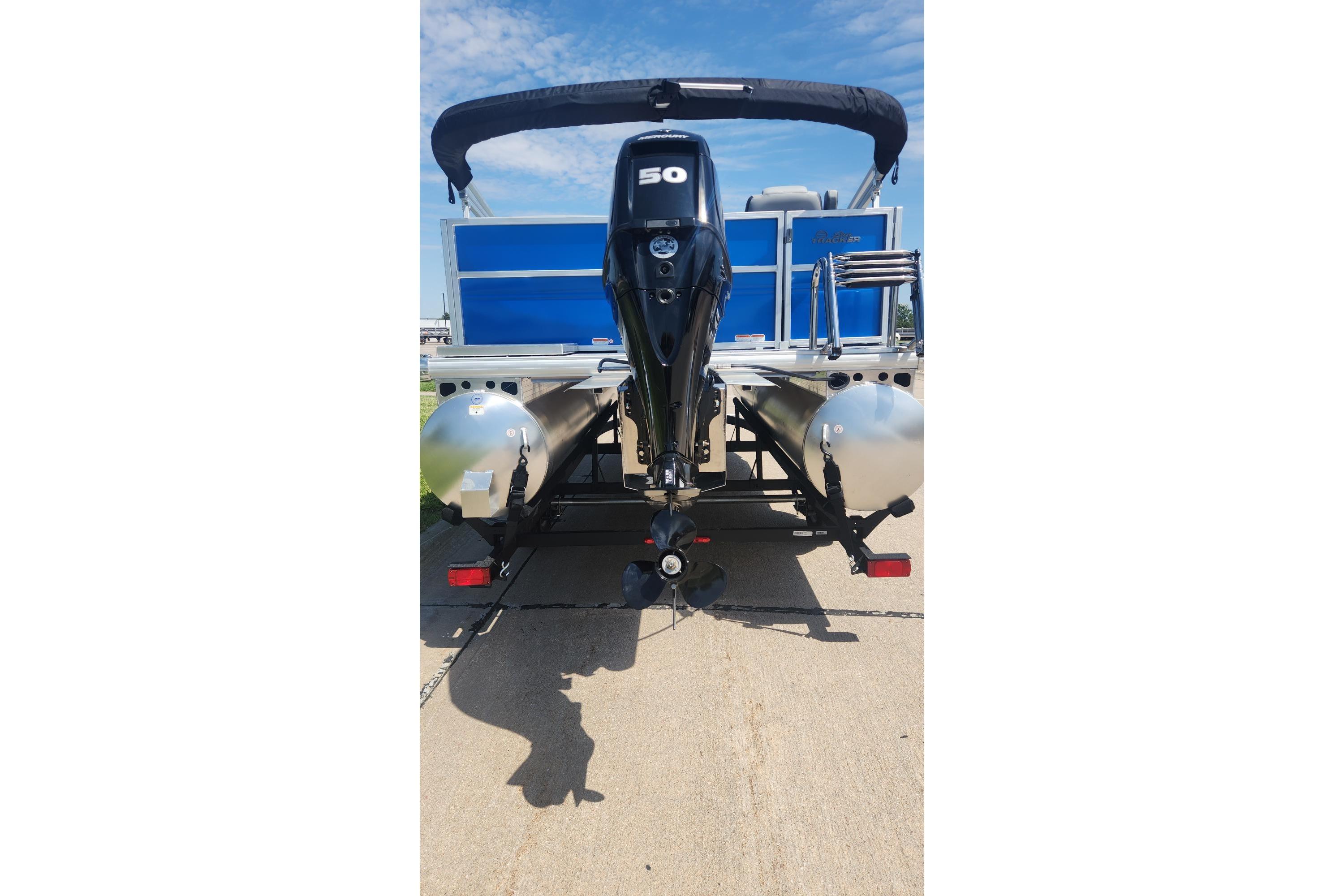 2026 Sun Tracker Party Barge 16 DLX pontoon boat with powerful outboard motor.