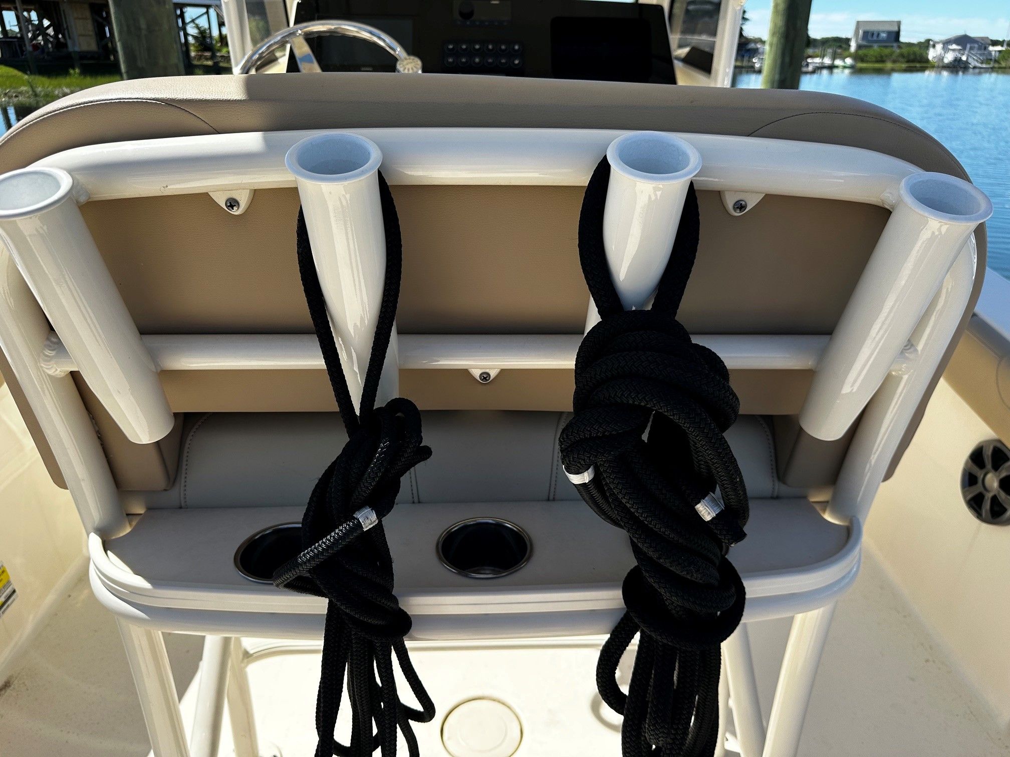 Scout 210XSF 2022 boat with fishing rod holders and ropes.